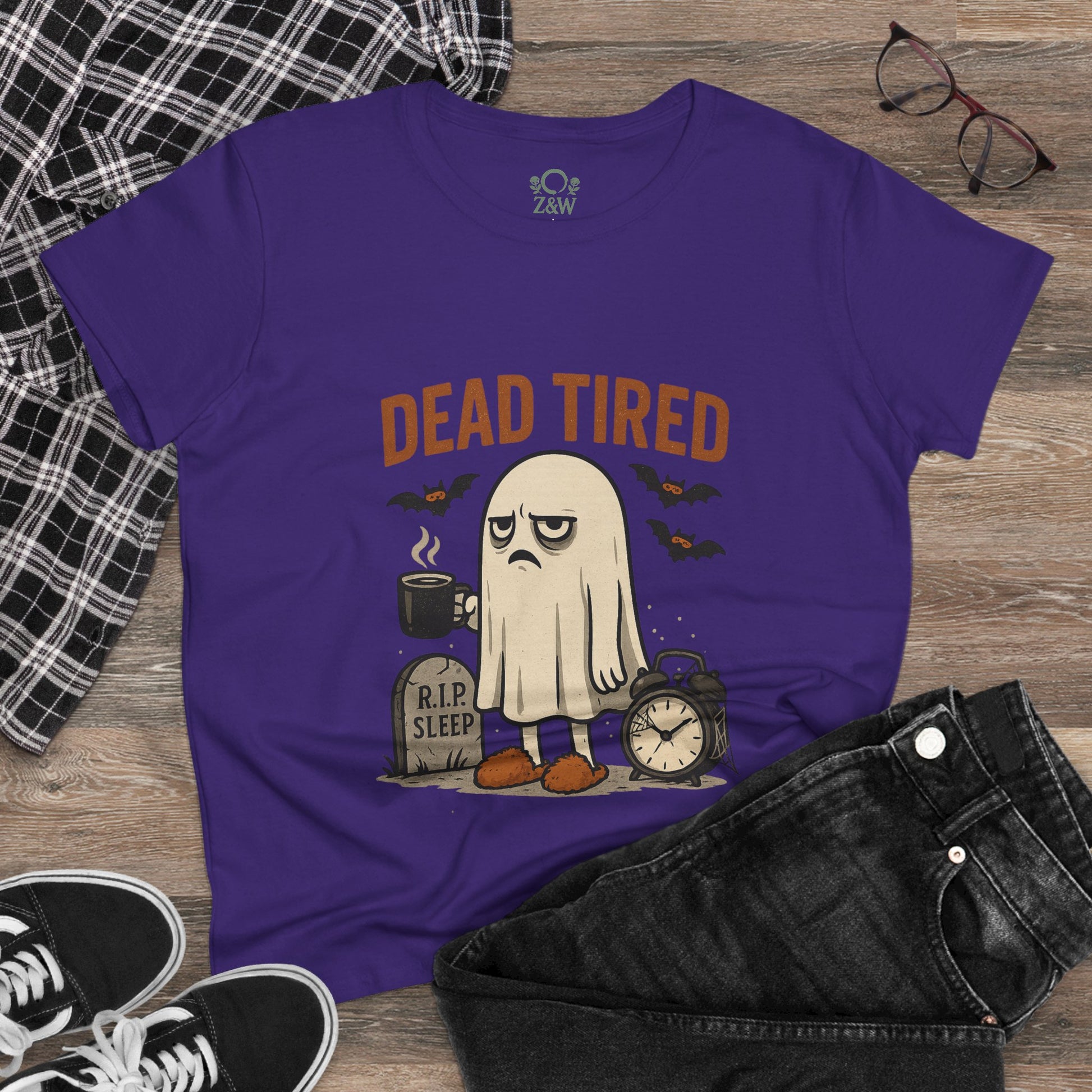Styled view of a Cute Whimsical Ghost T-Shirt for Halloween placed on a wooden background, perfect cozy 100% cotton unisex lounge shirt for gifts.