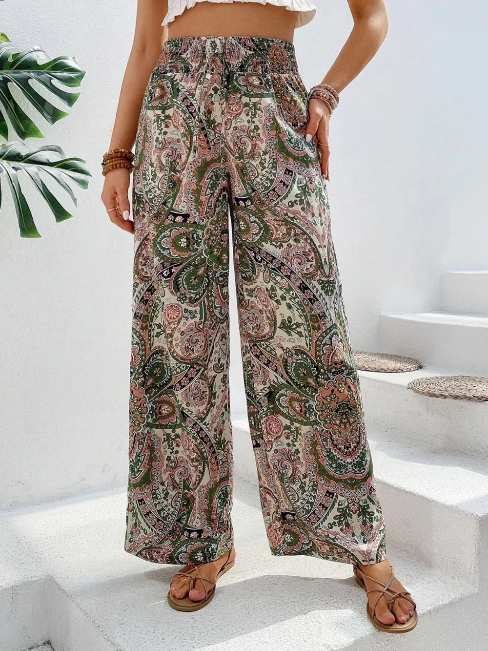 Trendy Printed Wide Leg Pants with Tied Detail, designed with elegant green and pink paisley patterns, complemented by a casual crop top for a fashionable, laid-back style.