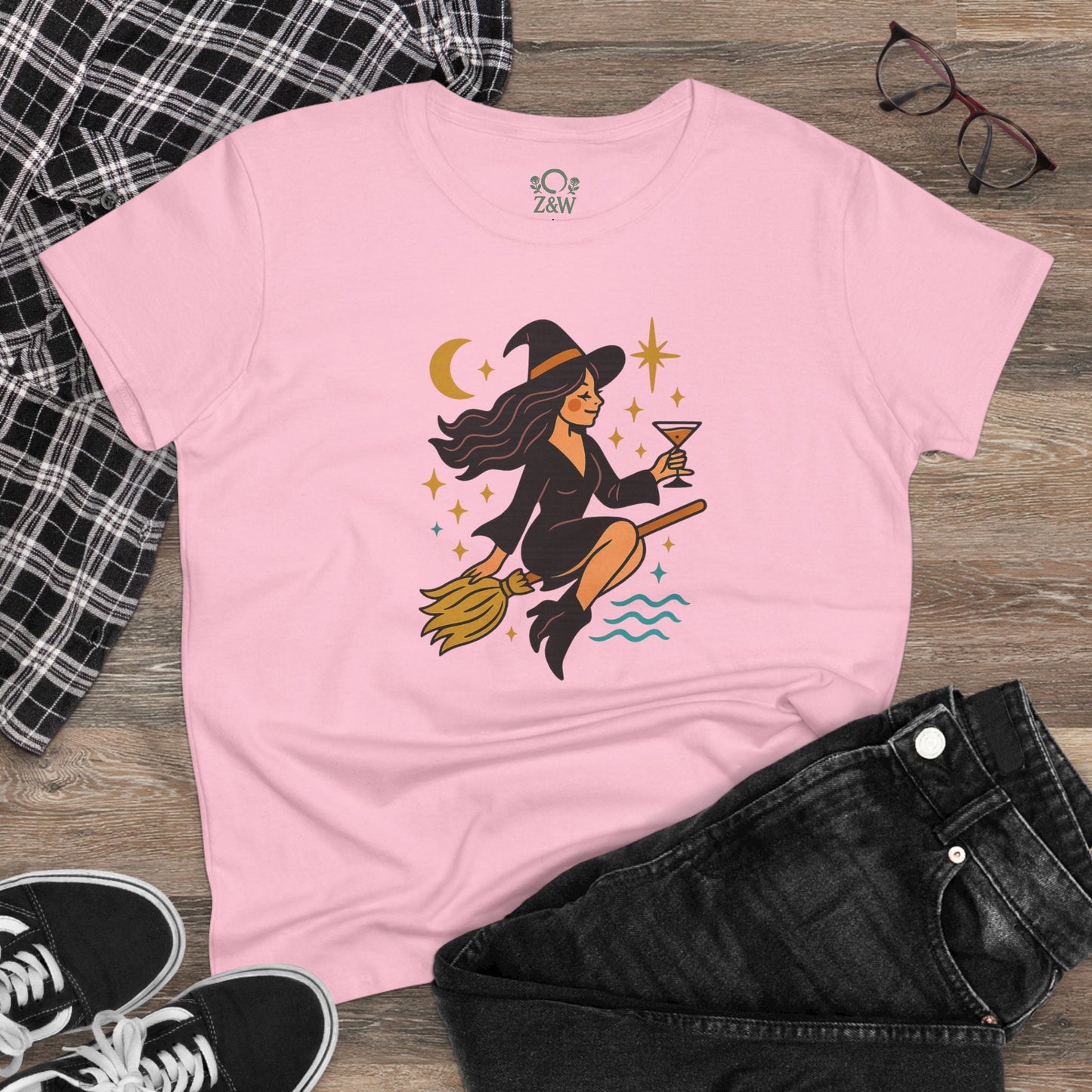 Witchy Night Out Tee featuring a stylish witch character with a broom and cocktail in vibrant design, crafted from 100% cotton for comfort and durability.