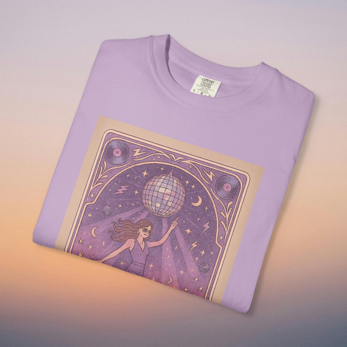 Groove Tarot Graphic Tee displayed in light purple, showcasing an artistic illustration of a woman with a disco ball, perfect for fashion-forward individuals.