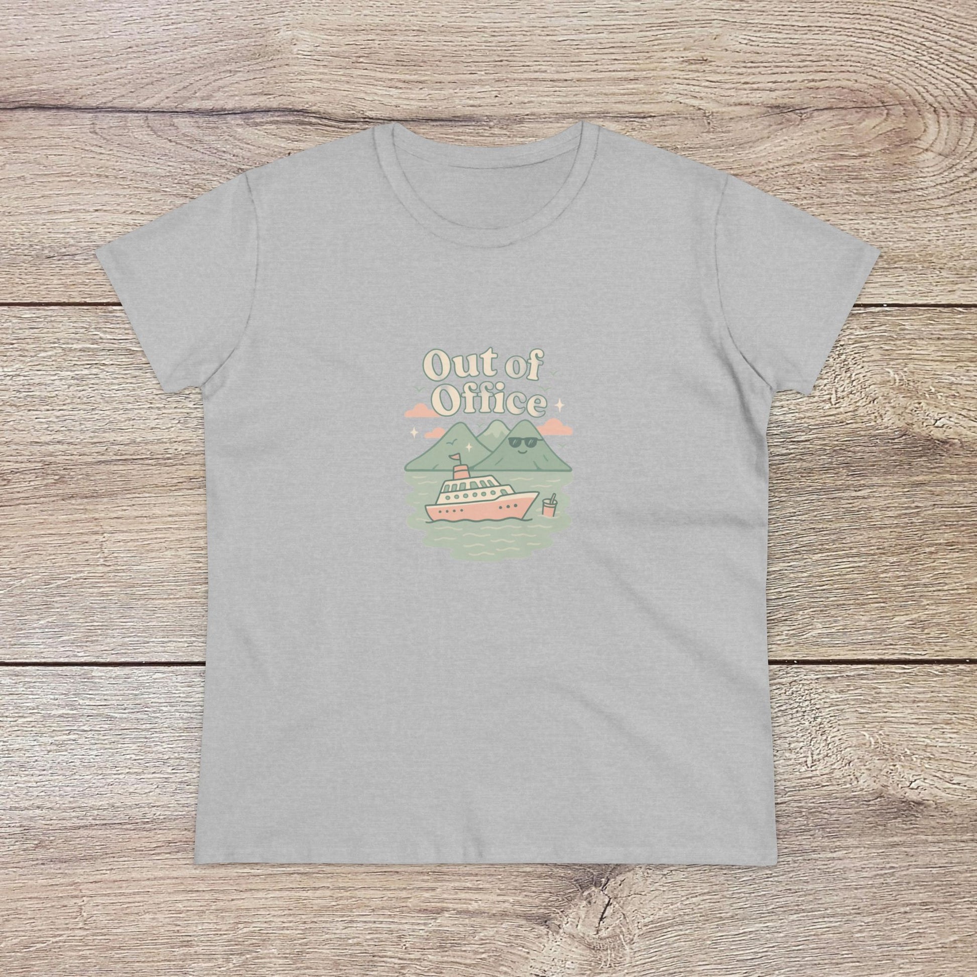 Out Of Office Cruise Tee in grey, showcasing a scenic boat design among mountains. Ideal for summer outings, made from a soft cotton blend.