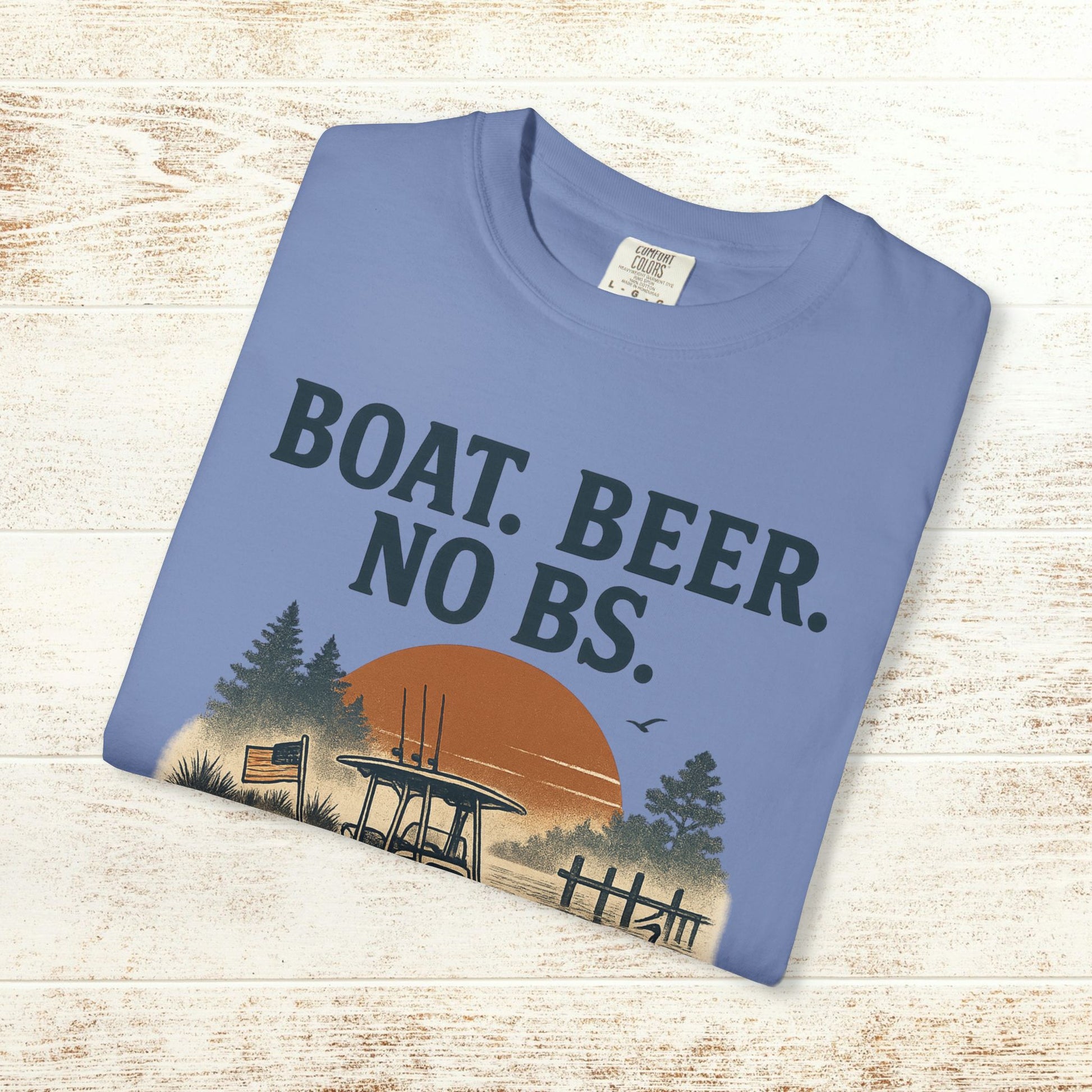 Boat Beer No BS Tee displayed flat in a light blue color, showcasing a stylish graphic with a boat and sunset, ideal for boat lovers and casual wear.