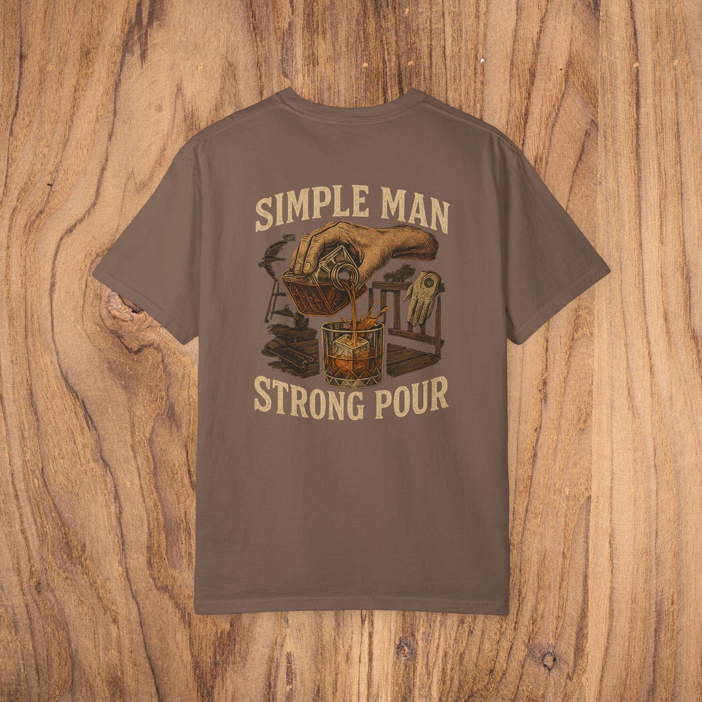 Simple Man Strong Pour T-Shirt in earthy brown featuring a vintage hand-drawn design pouring a drink, highlighting ethical sourcing and classic fit with 100% cotton for maximum comfort.