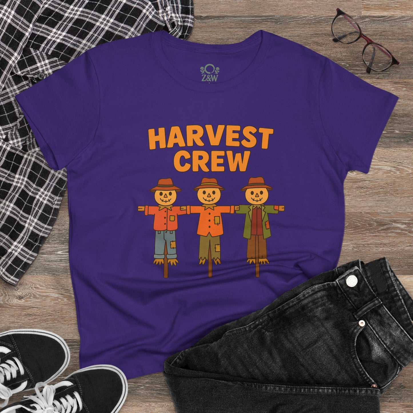 Casual look featuring the Harvest Crew Halloween T-Shirt - Soft 100% Ring-Spun Cotton in purple, styled with black jeans and sunglasses, highlighting its playful scarecrow design.