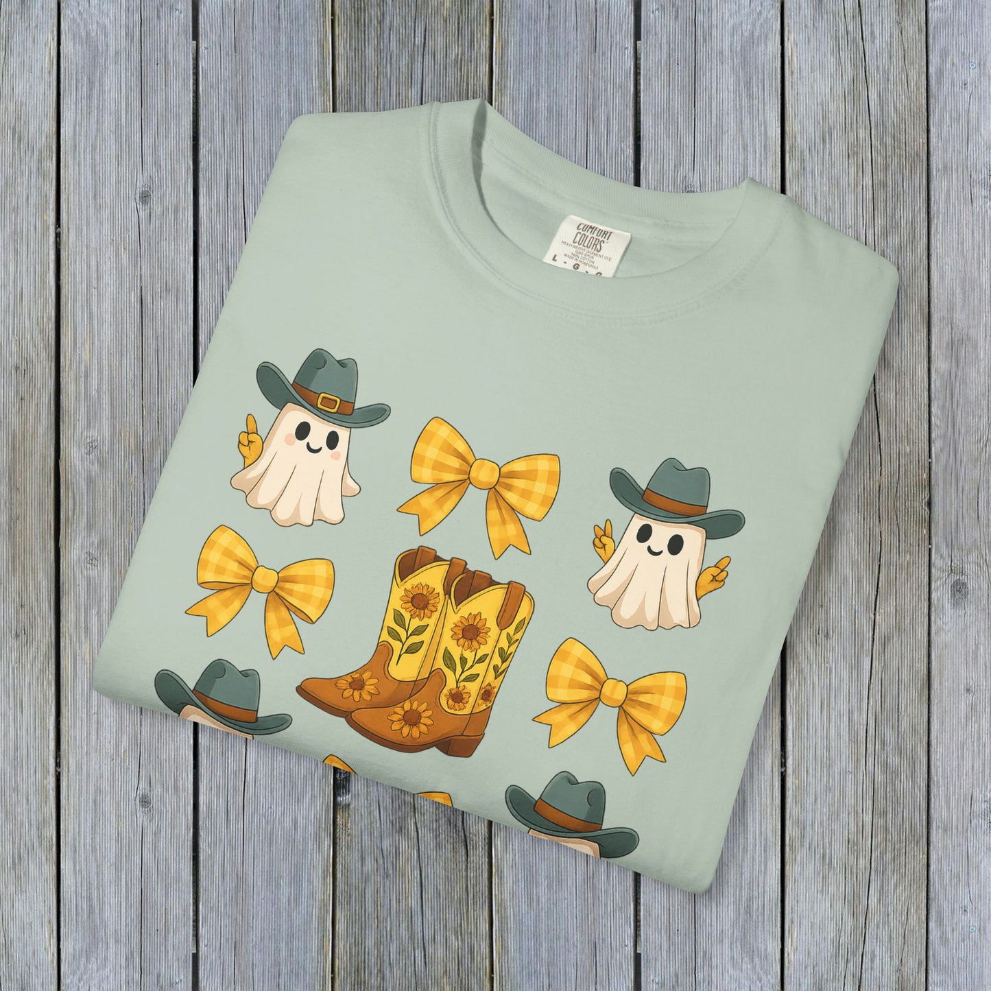 Cute Halloween T-Shirt in soft green color showcasing cute ghosts and cowboy boots, an excellent choice for unisex fall fashion, made from eco-friendly fabric.