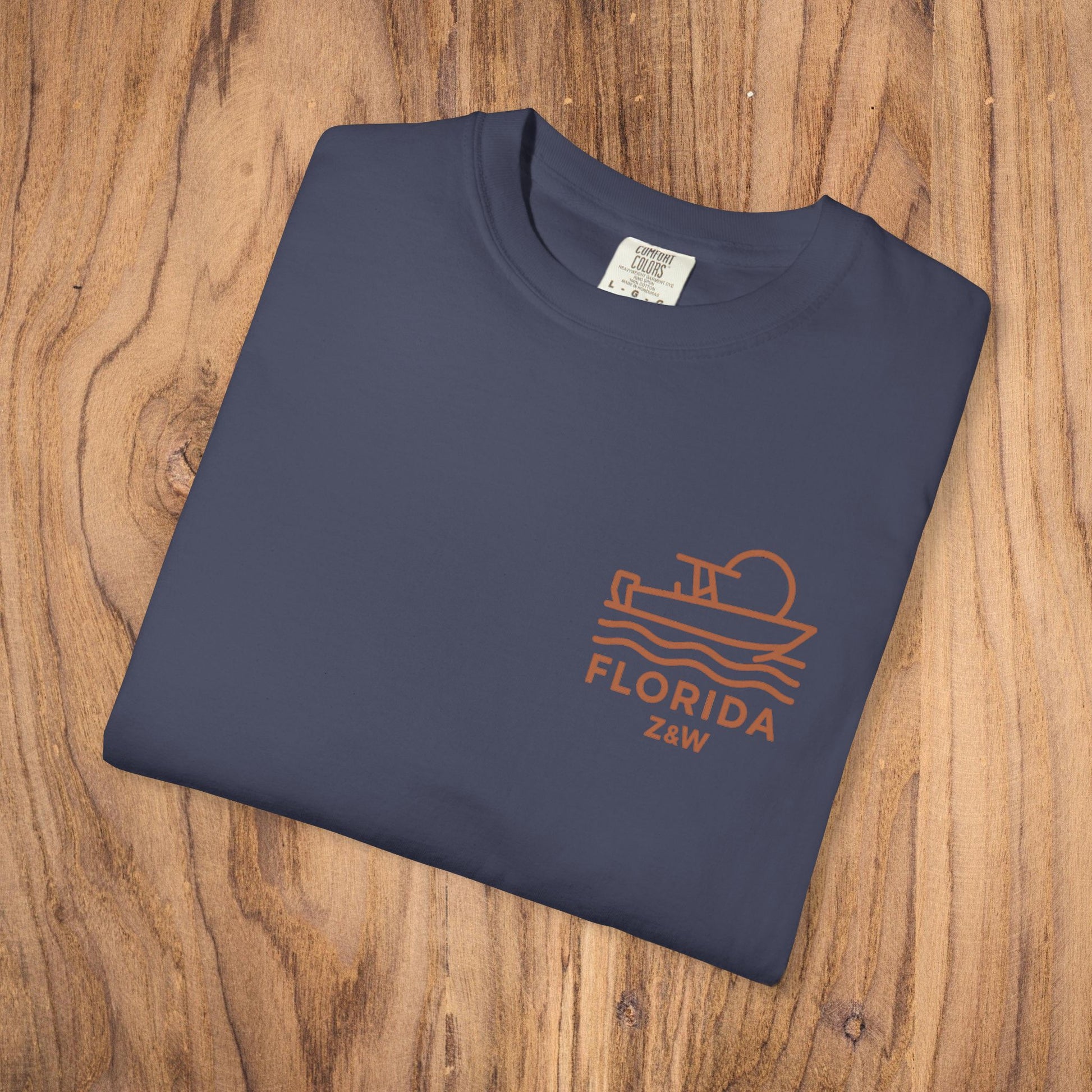 Unisex Florida Graphic Tee in deep navy color, displayed flat on rustic wooden background, perfect addition to any wardrobe.