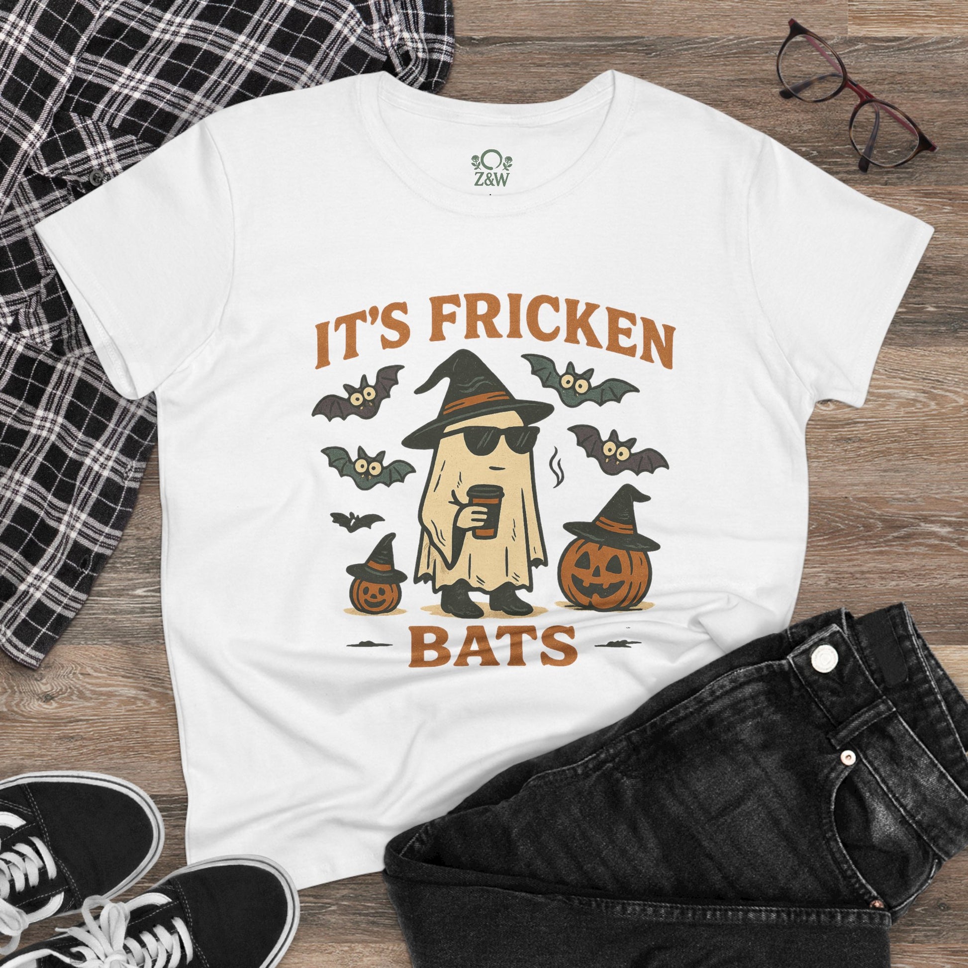 Stylish Halloween unisex t-shirt showcasing a ghost graphic with sunglasses alongside bats and pumpkins, ideal for festive celebrations. Crafted from 100% cotton.