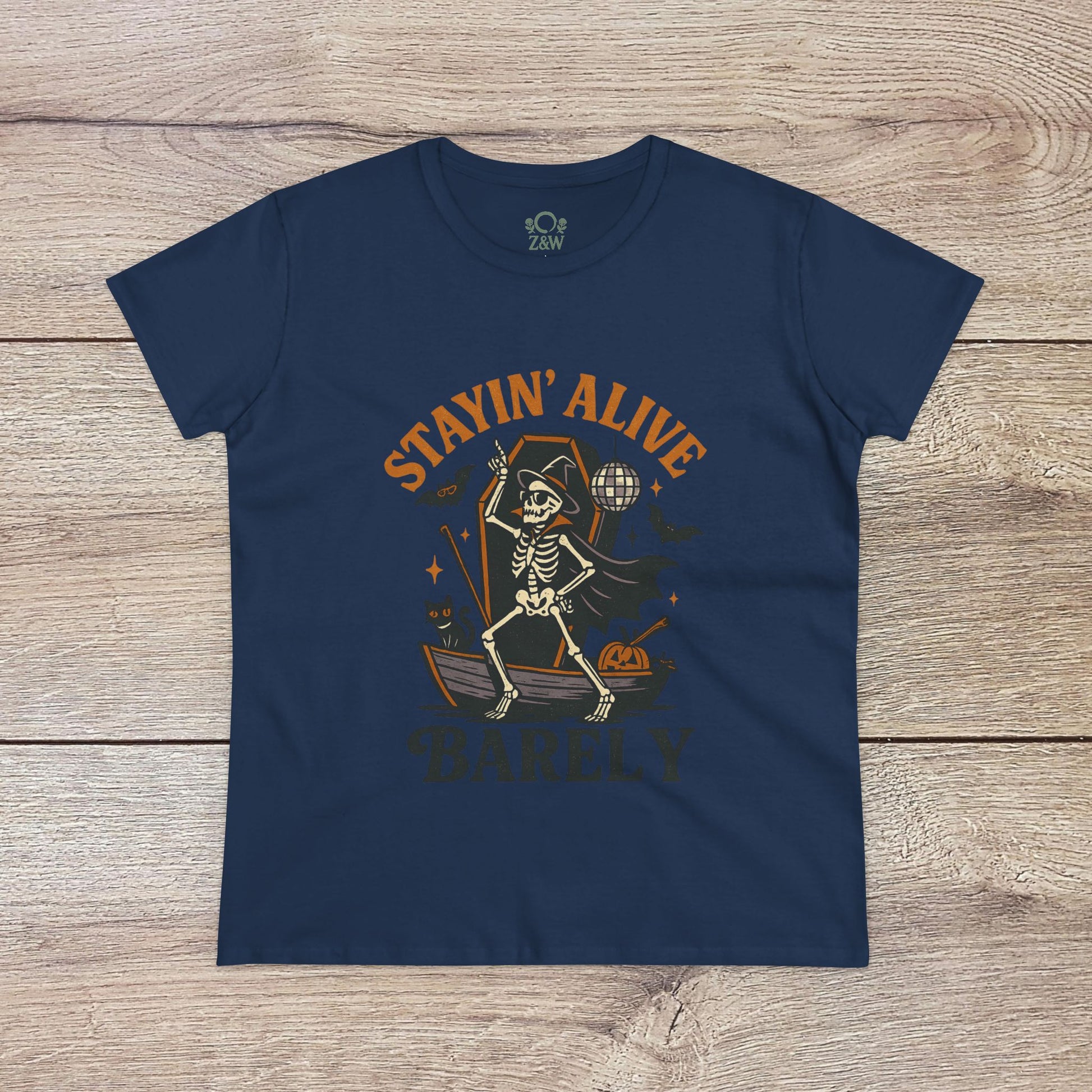 Stayin’ Alive T-Shirt in classic navy featuring a humorous skeleton illustration, great for Halloween festivities. Softstyle unisex t-shirt for any occasion.