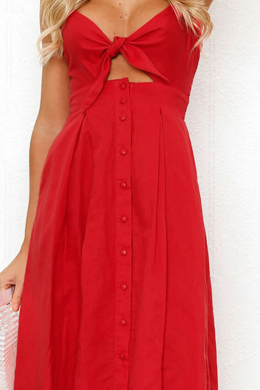 Close-up shot of the Cutout Smocked Sweetheart Neck Cami Dress with Decorative Button and Opaque Design in red, emphasizing the button details and sweetheart neckline.