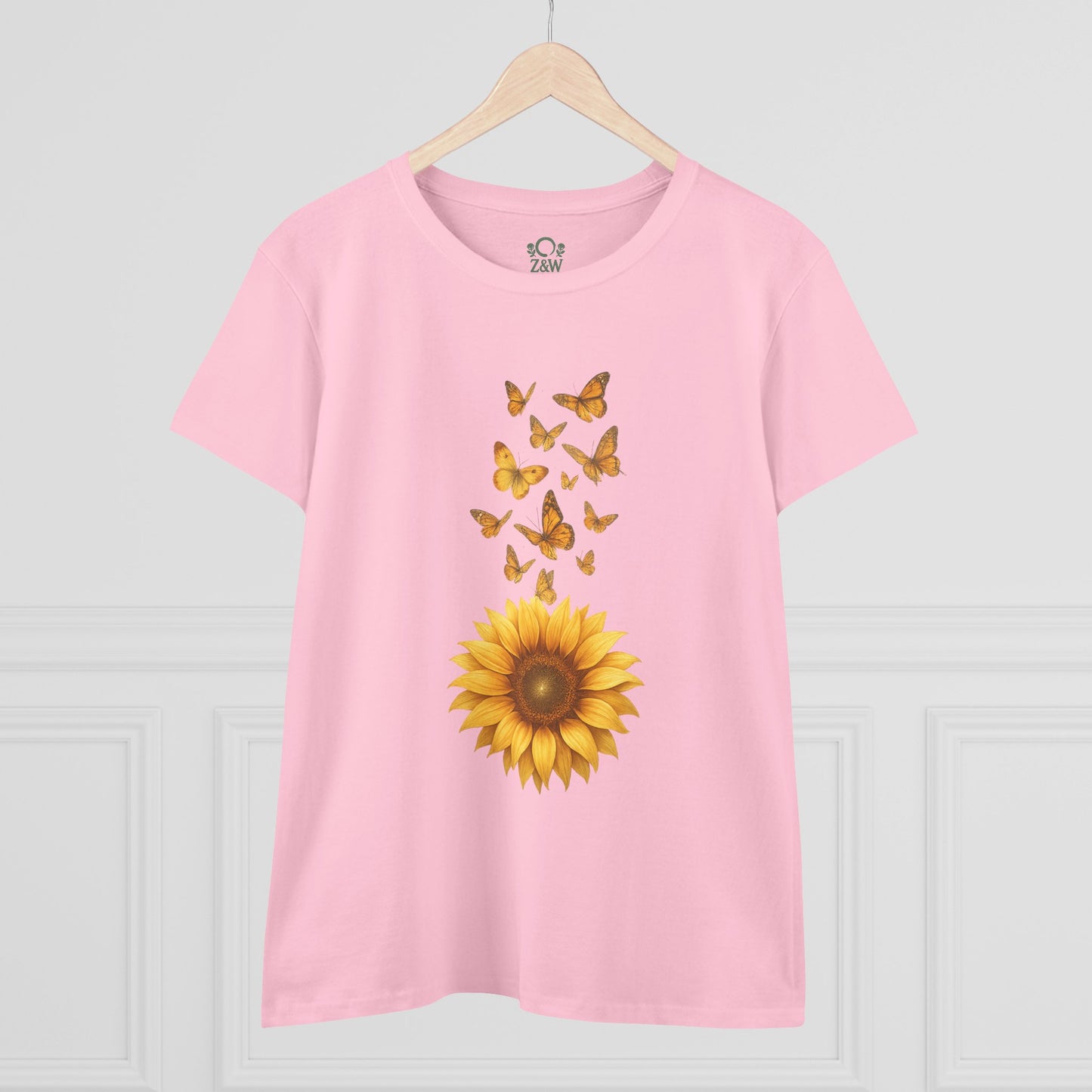 Sunflower & Butterflies Cotton Tee for Women in light pink, presented in a stylish setting with a sunflower and butterfly design, made from 100% soft cotton for a comfortable and fashionable look.