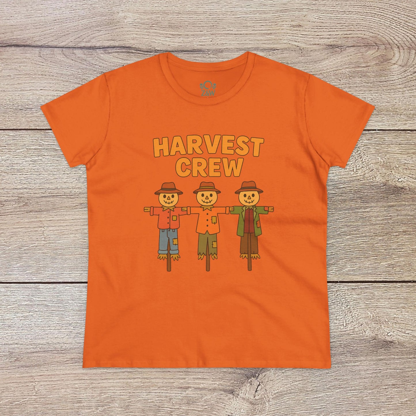 Harvest Crew Halloween T-Shirt in vibrant orange featuring a charming trio of scarecrows, made from soft 100% ring-spun cotton for a cozy fit.