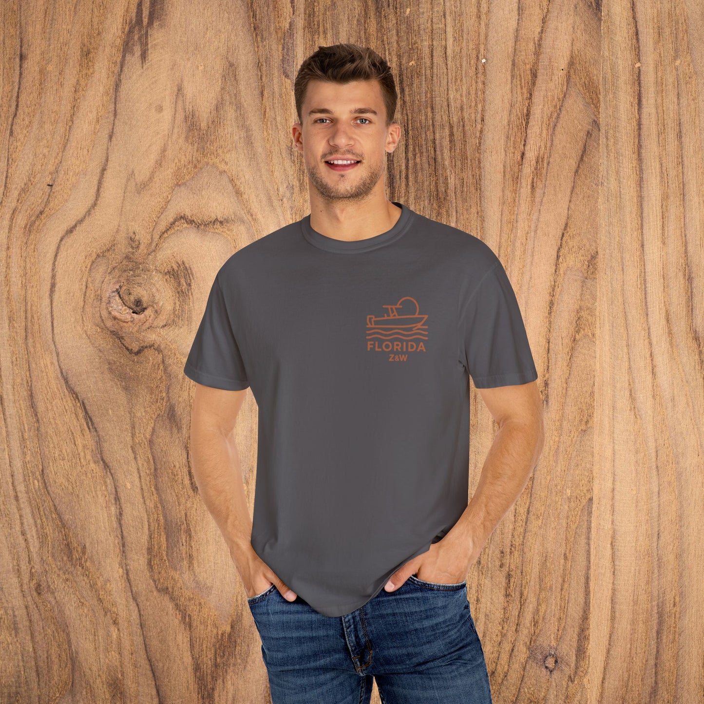 Man in a gray Unisex Florida Graphic Tee with a stylish boat design, made from comfortable US cotton, suitable for any casual occasion.