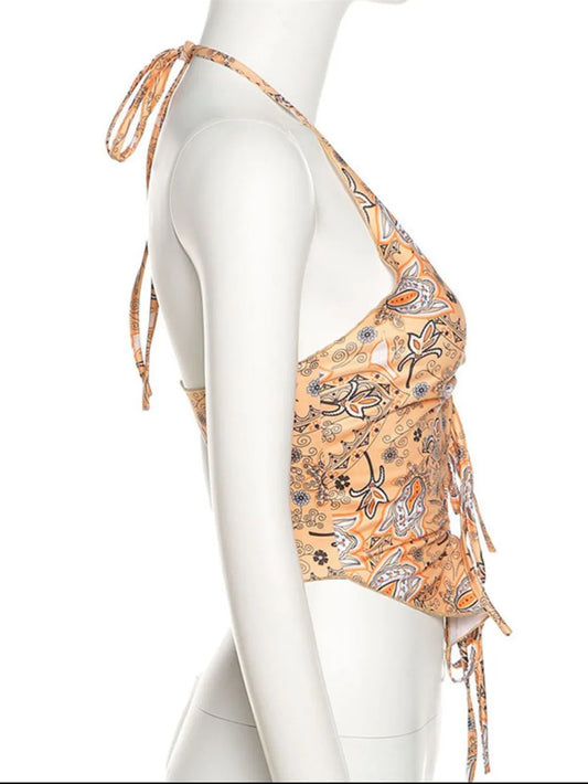 Side view of the Trendy Printed Halter Neck Cami Top on a mannequin, highlighting its unique tie design and stretchable fit, perfect for casual outings.