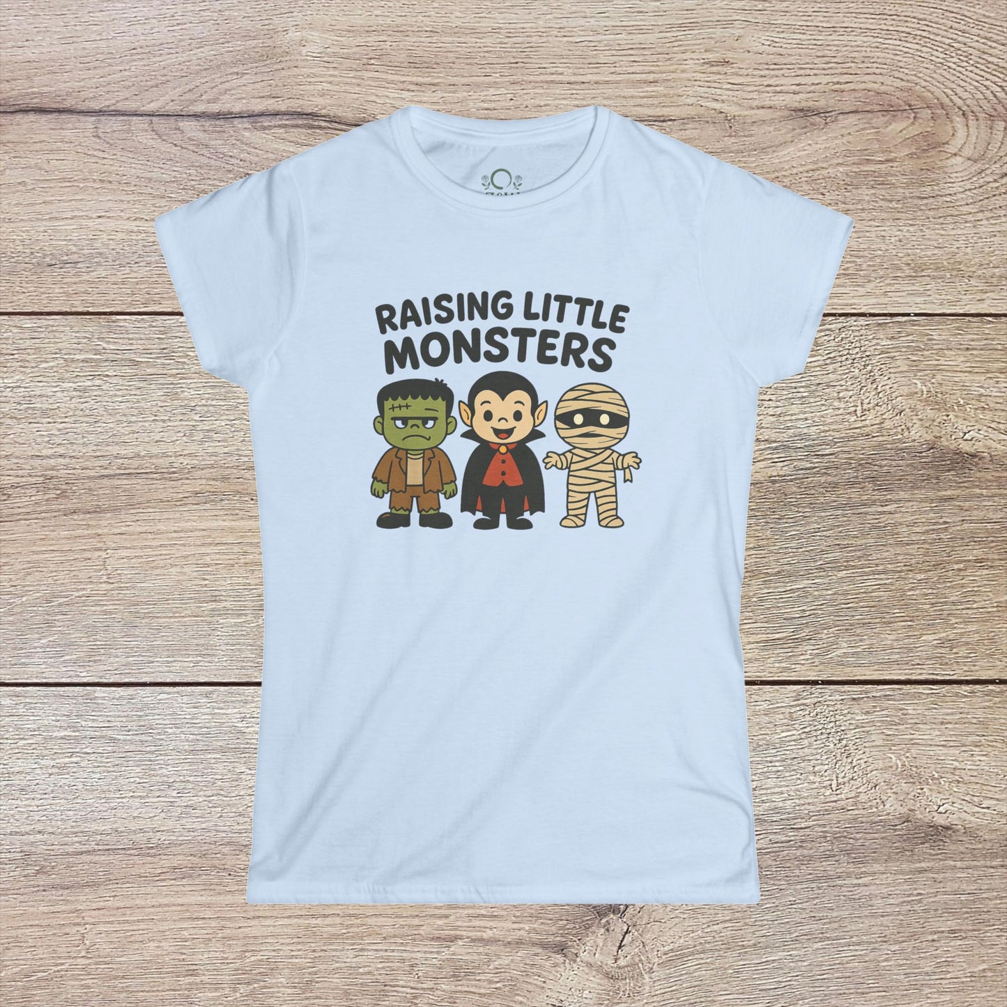 Light blue Halloween Family T-Shirt with adorable illustrations of Frankenstein, a vampire, and a mummy, ideal for festive events - Raising Little Monsters Cute Kids Tee.