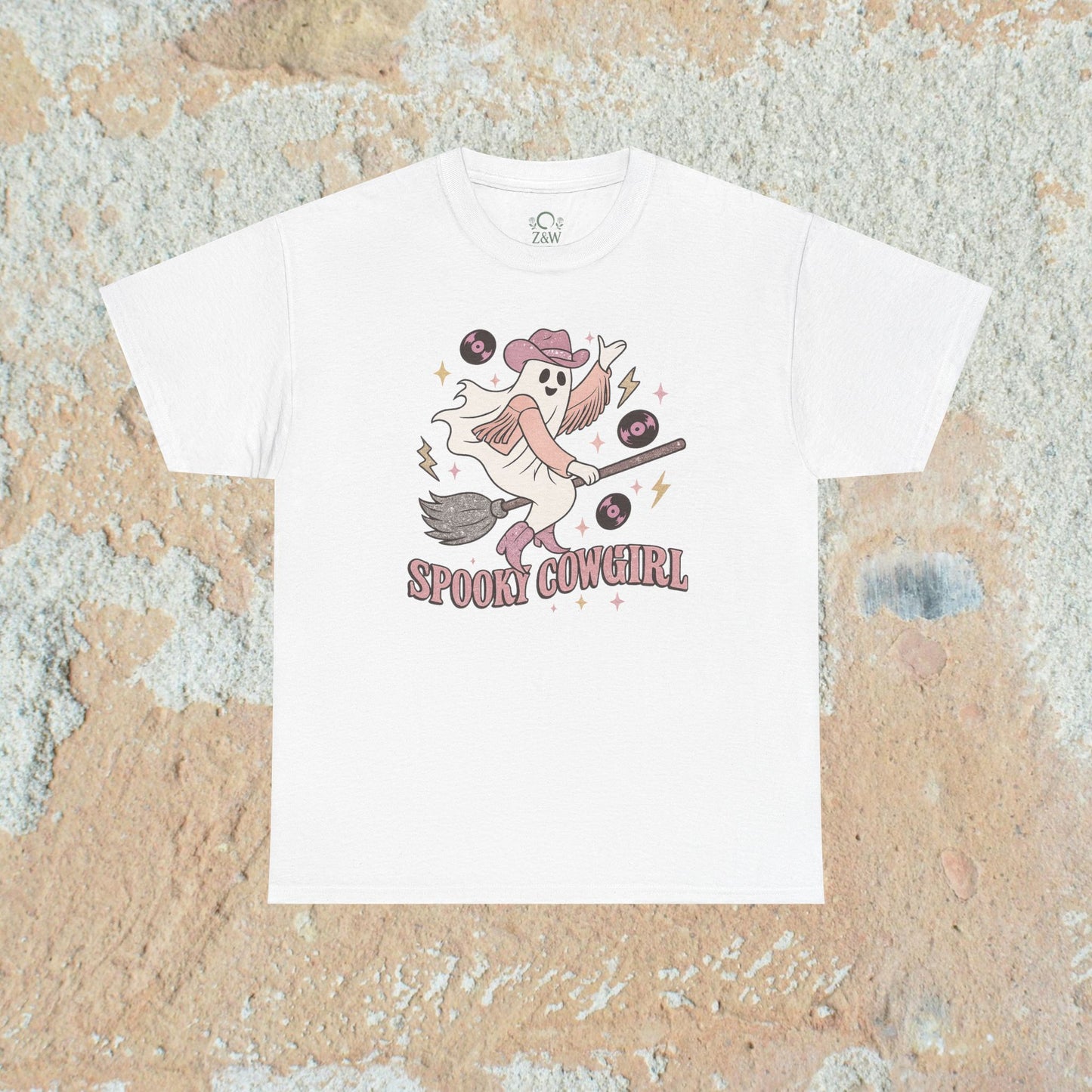Spooky Cowgirl Graphic Tee in classic white, displaying a spirited ghost in a hat riding a broom, perfect for showcasing your Halloween style.
