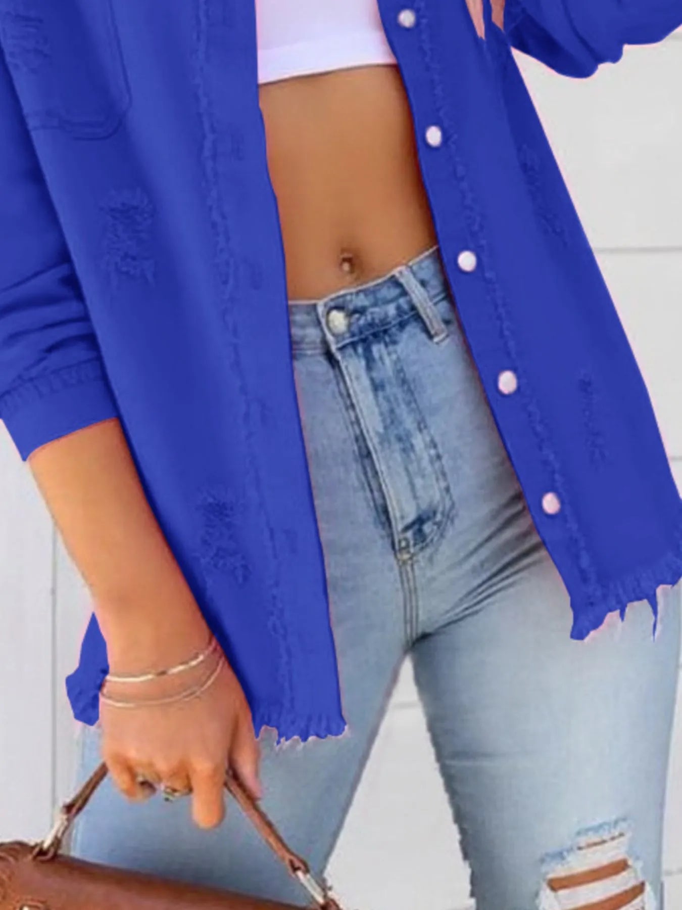 Detail shot of the Oversized Distressed Denim Jacket with Frayed Edges and Buttoned Pockets in blue, emphasizing style and comfort for trendy casual looks.