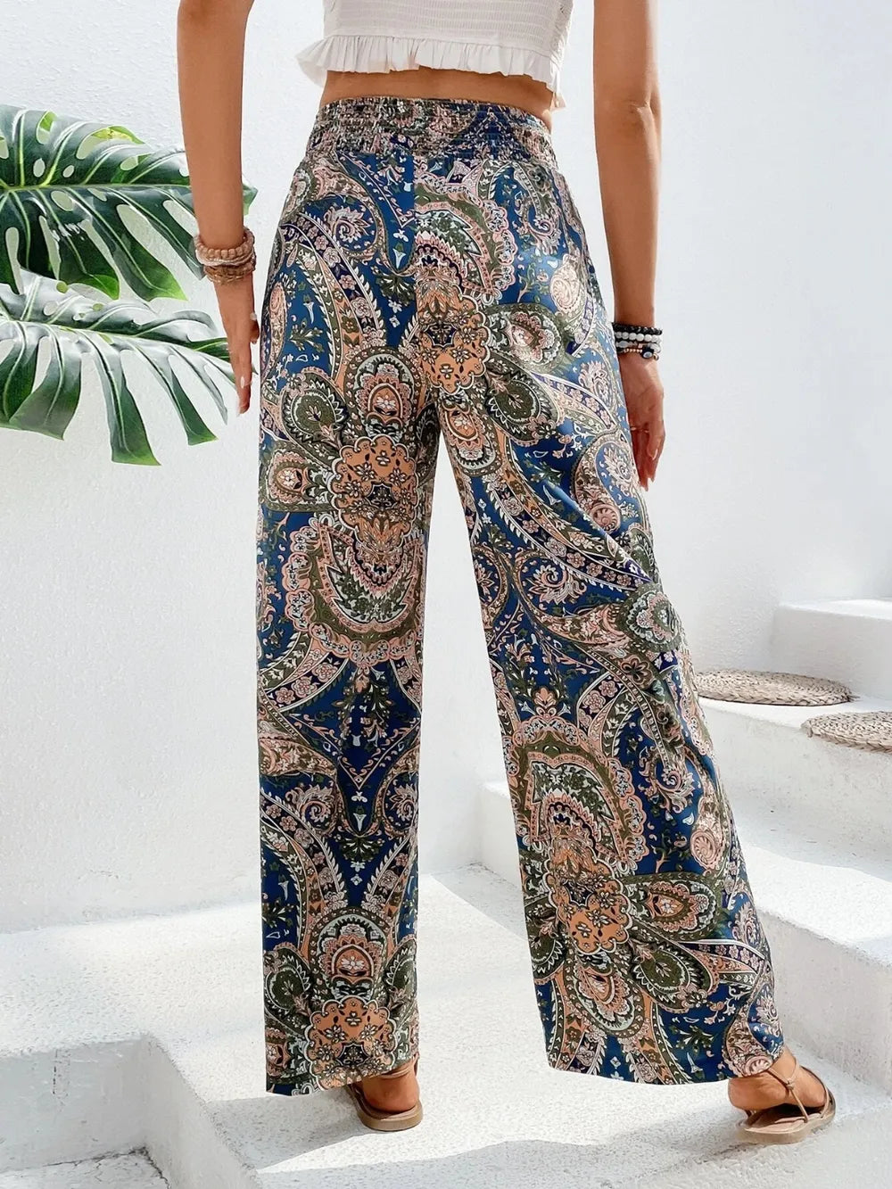 Back view of Trendy Printed Wide Leg Pants with Tied Detail showcasing a vibrant paisley design, ideal for any occasion, crafted from 100% opaque polyester.