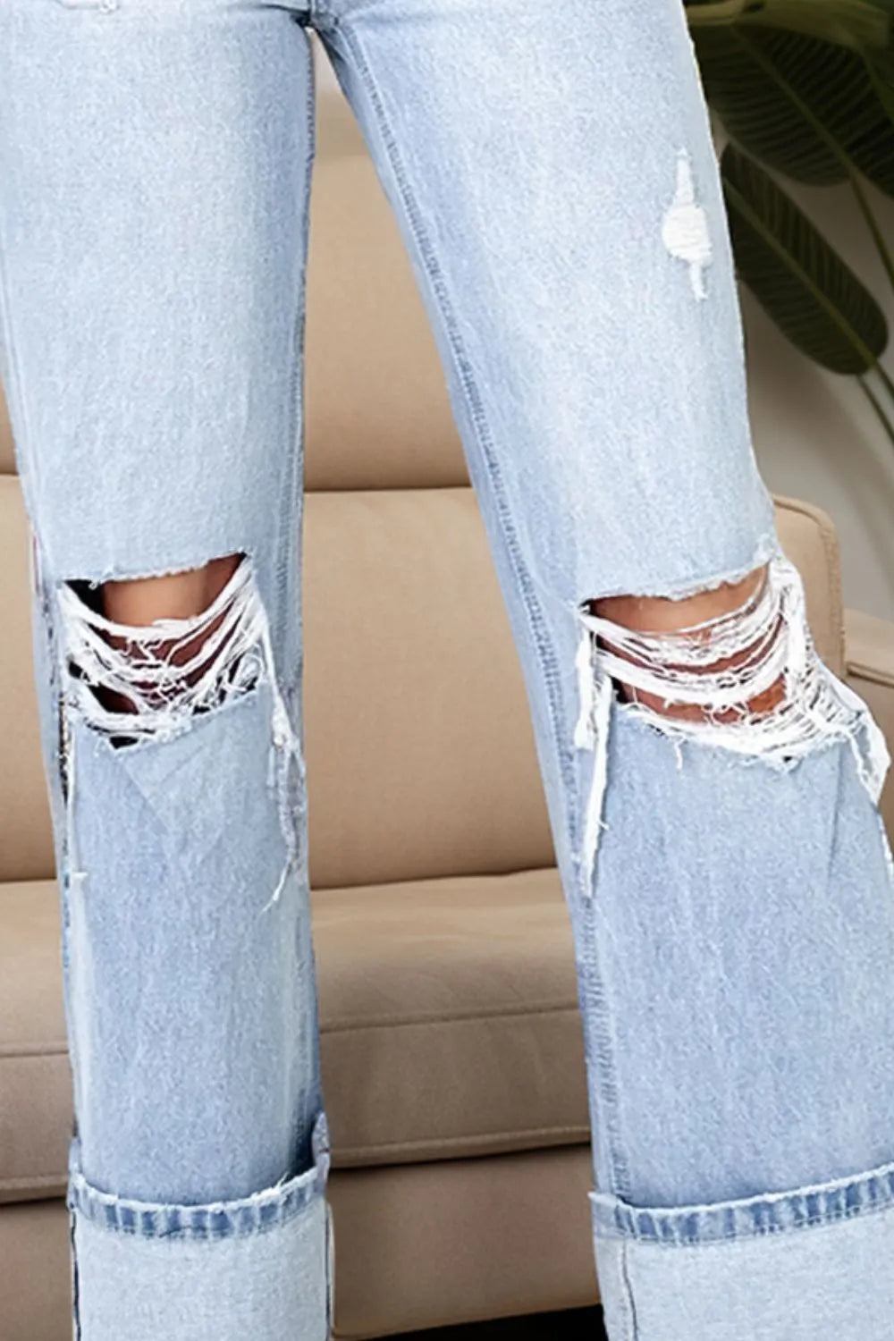 Close-up of Trendy Distressed High Waist Jeans with Pockets - Slightly Stretchy Comfort Fit, highlighting the torn knee area and frayed edges for an on-trend look.