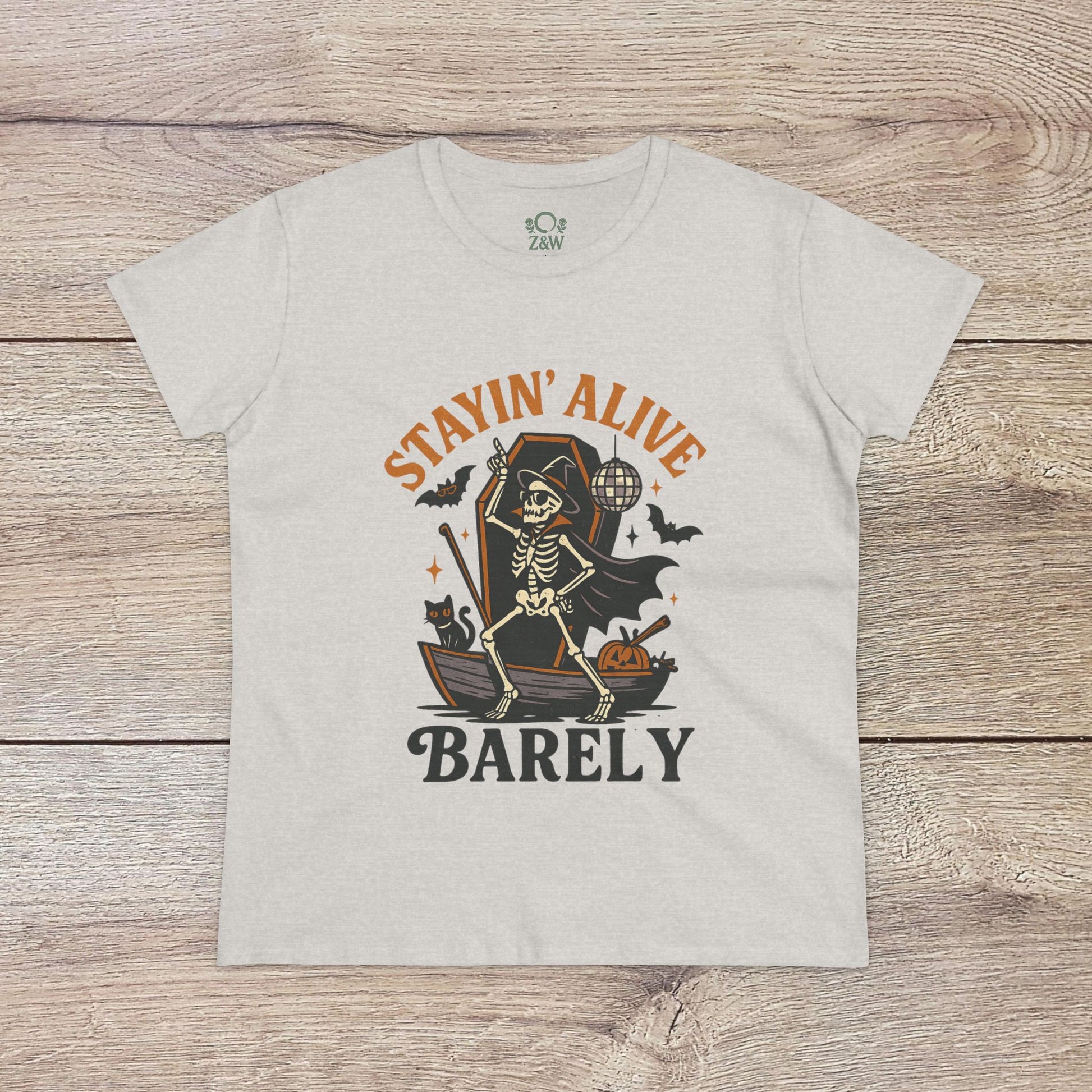 Stayin’ Alive T-Shirt in grey featuring a whimsical skeleton print with the words 'BARELY', great for Halloween festivities or as a unique gift.