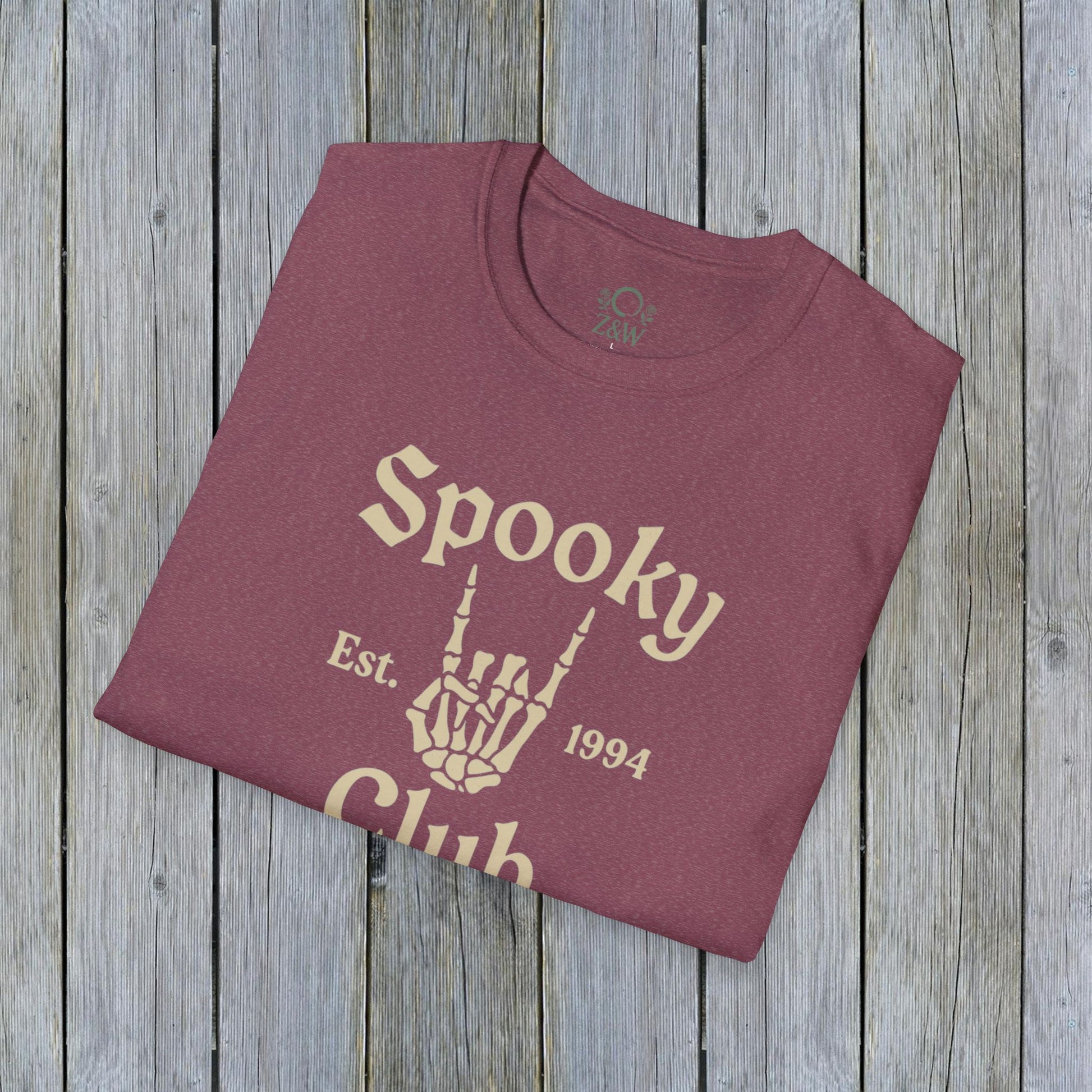 Unisex Spooky Club Tee in burgundy, displaying a skeleton hand graphic alongside 'Spooky Club Est. 1994' wording, designed with soft and durable 100% cotton.
