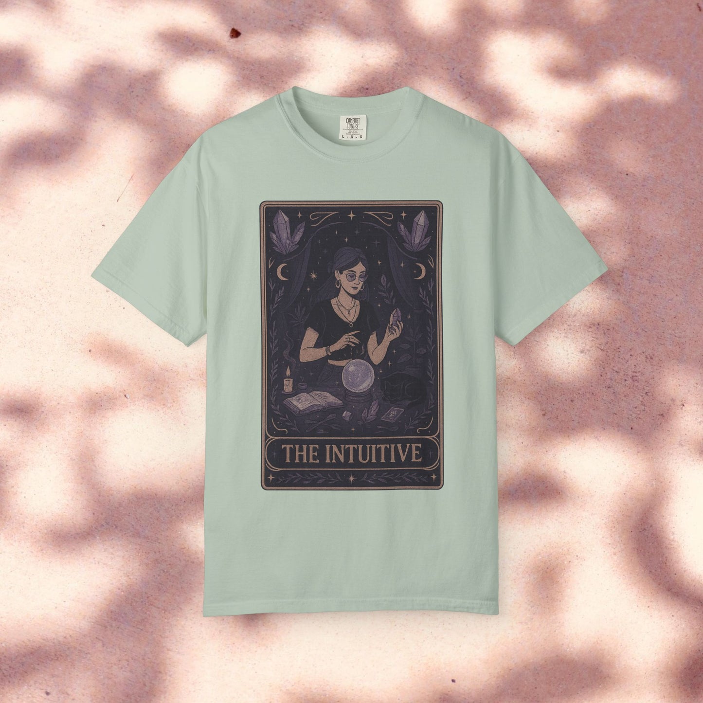 Intuitive Tarot Tee in pastel green, featuring a mystical design of a woman reading tarot cards, constructed from 100% soft cotton for comfort.