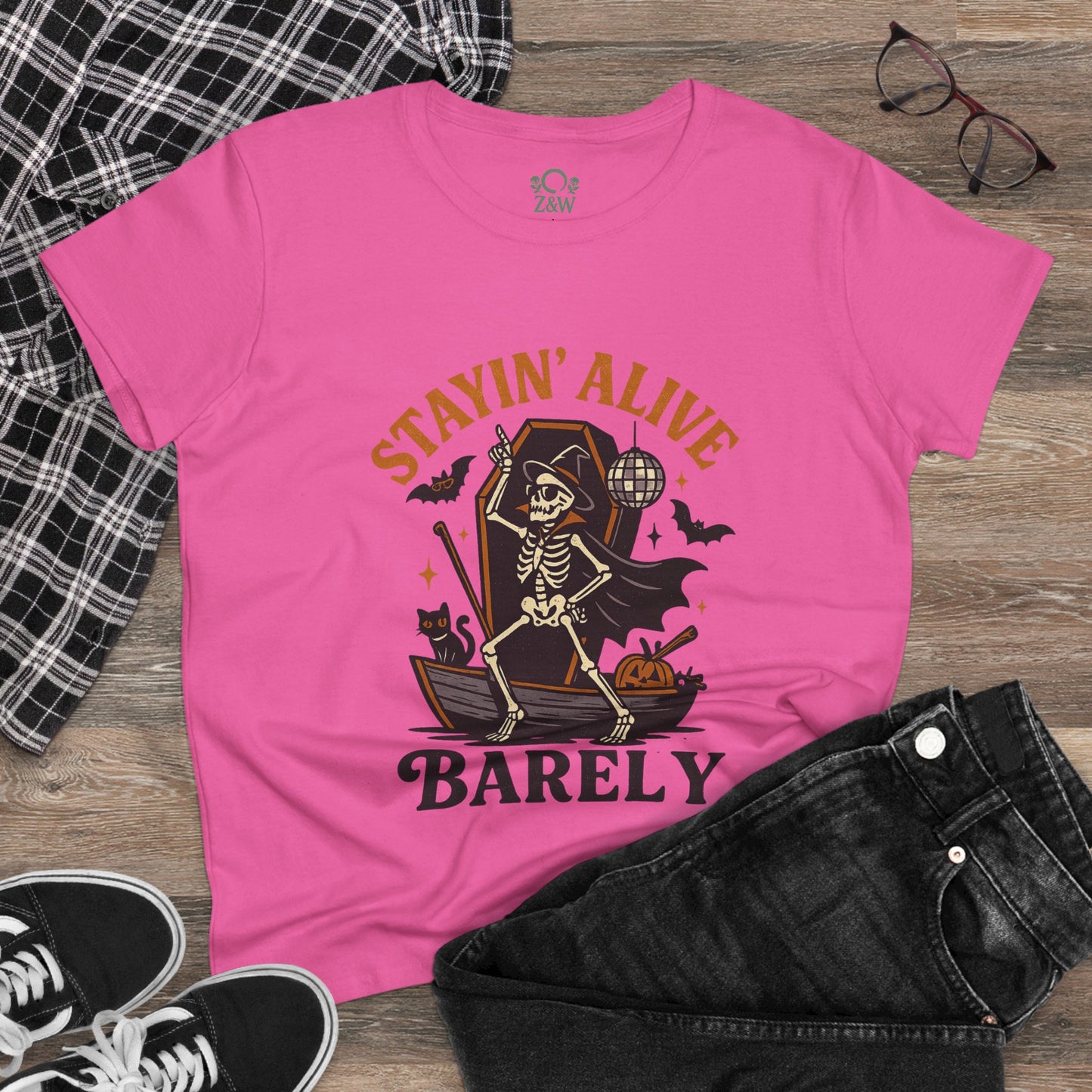 Stylish image of the Stayin’ Alive T-Shirt showing off a skeleton motif in a pink hue, ideal for casual wear and festive celebrations.