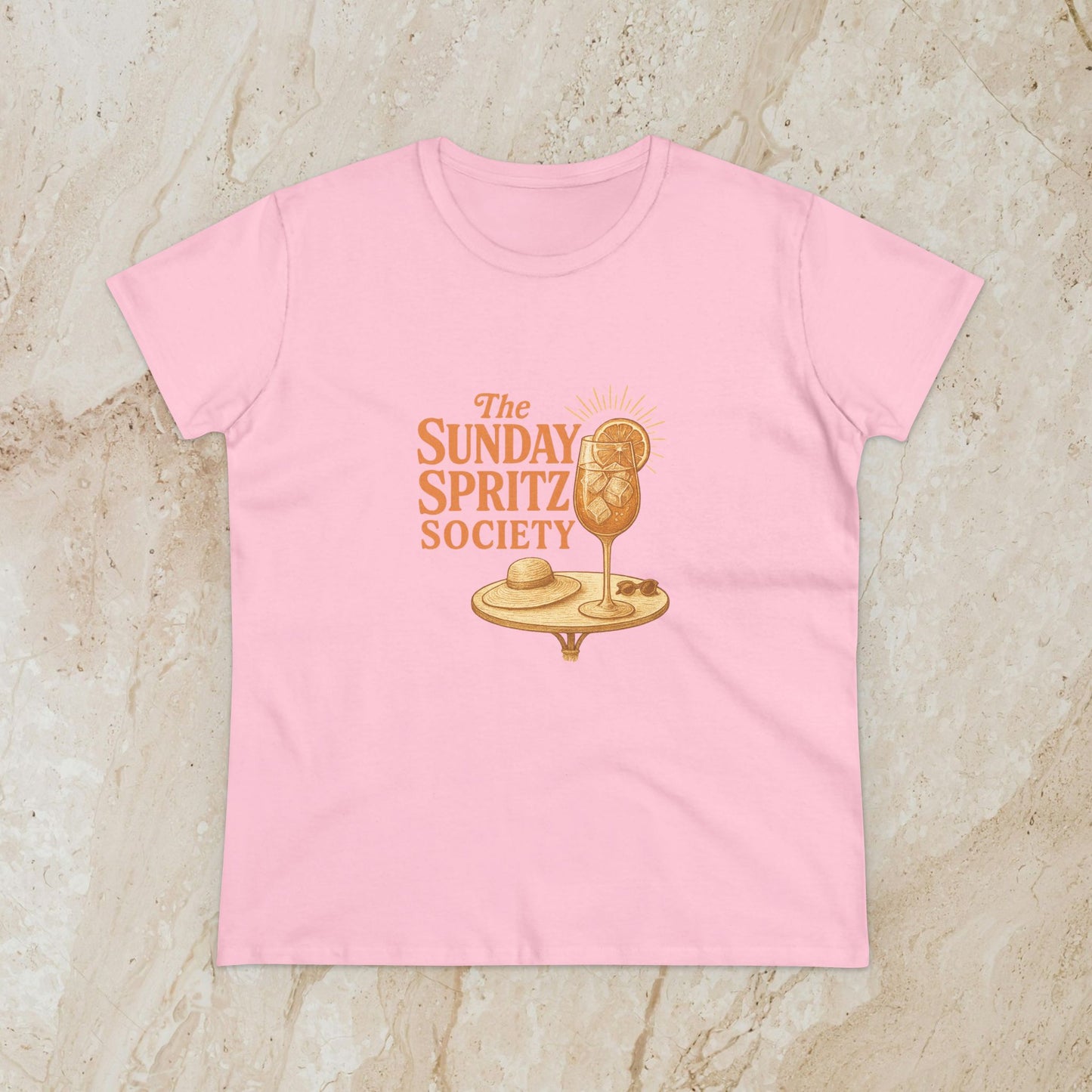 Soft pink Women's Midweight Cotton Tee with 'The Sunday Spritz Society' logo, ideal for sunny days and weekend adventures.