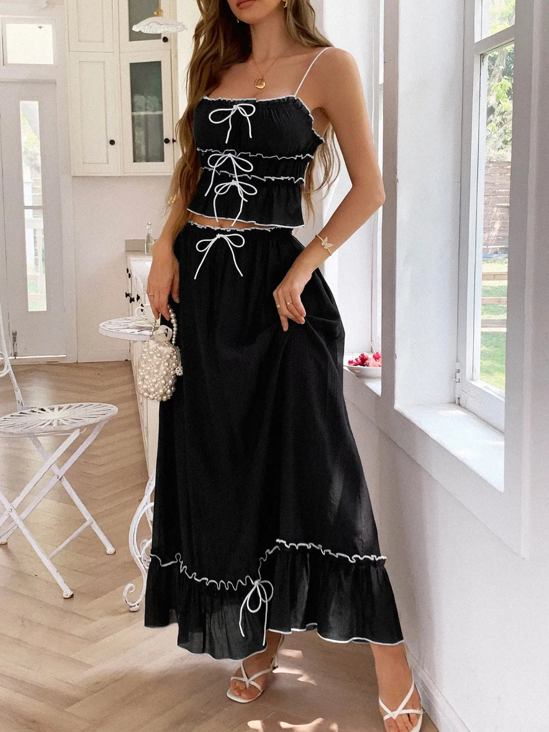 Front view of a model in a black Two-Piece Frill Square Neck Cami and Ruched Skirt Set in Stretchy Lyocell Blend, featuring tied accents and a flattering silhouette.