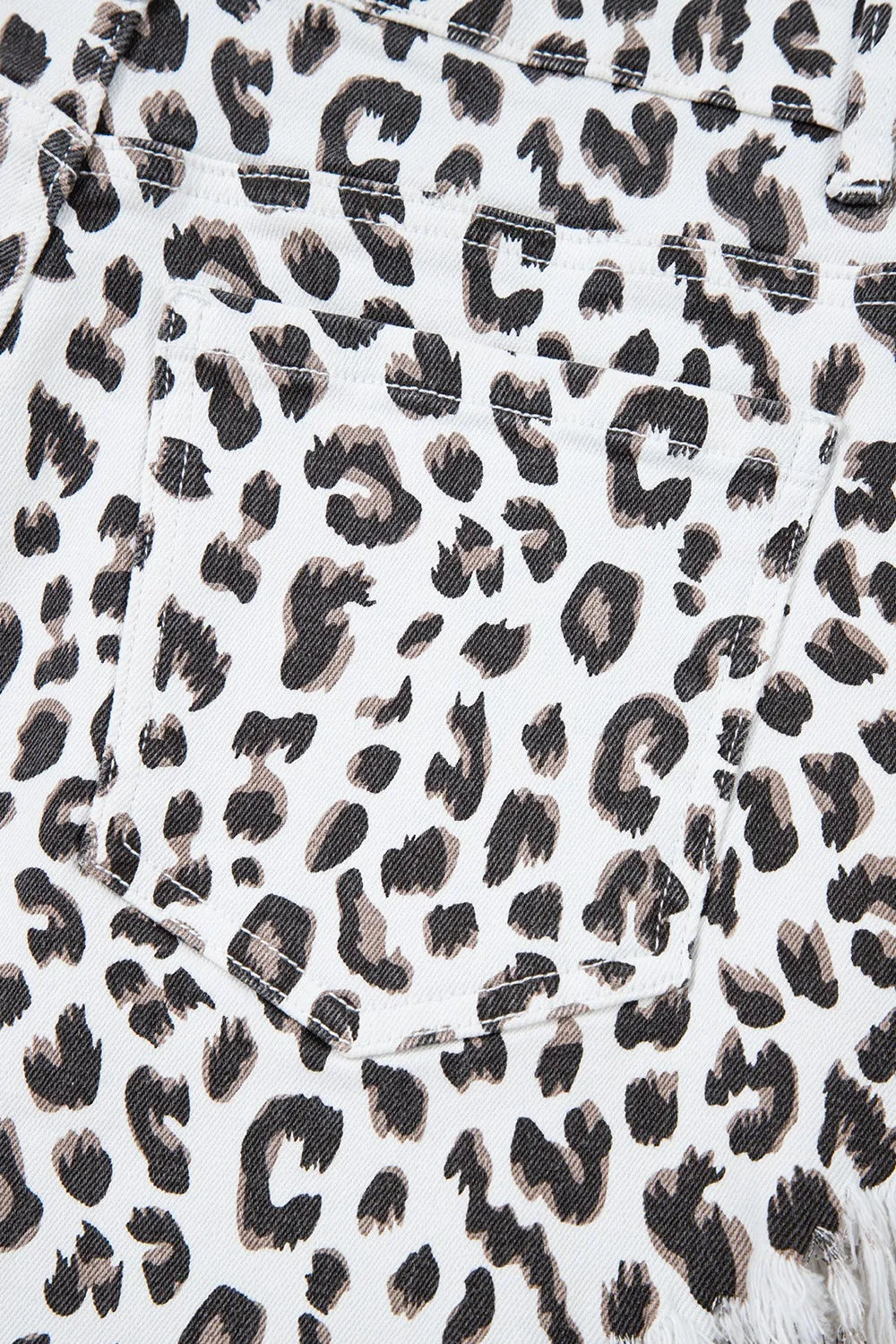Back pocket detail of Leopard Frayed Hem Denim Shorts - Accent on leopard print and functional design.