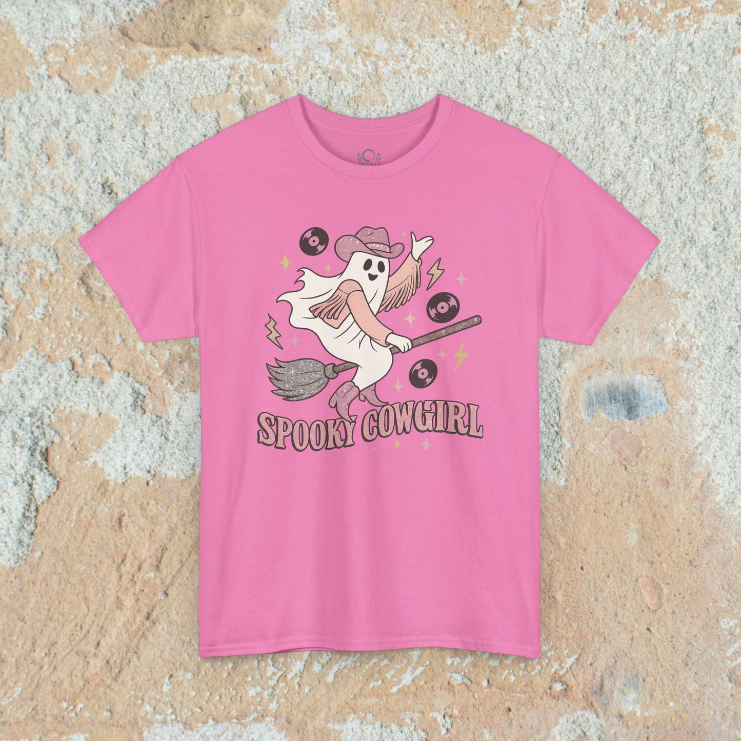 Spooky Cowgirl Graphic Tee in a cheerful pink shade, showcasing a whimsical ghost with a broom and records, perfect for a stylish Halloween look.