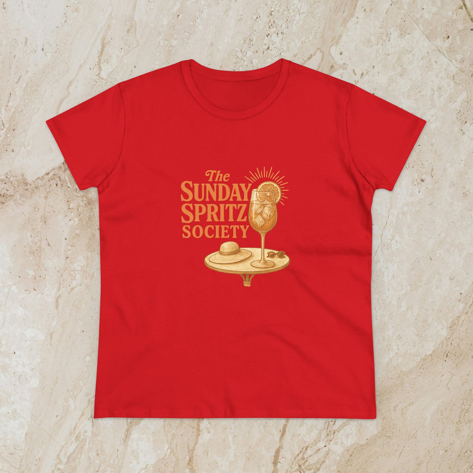 Bold red Women's Midweight Cotton Tee showcasing 'The Sunday Spritz Society' print, a perfect choice for relaxed summer days.