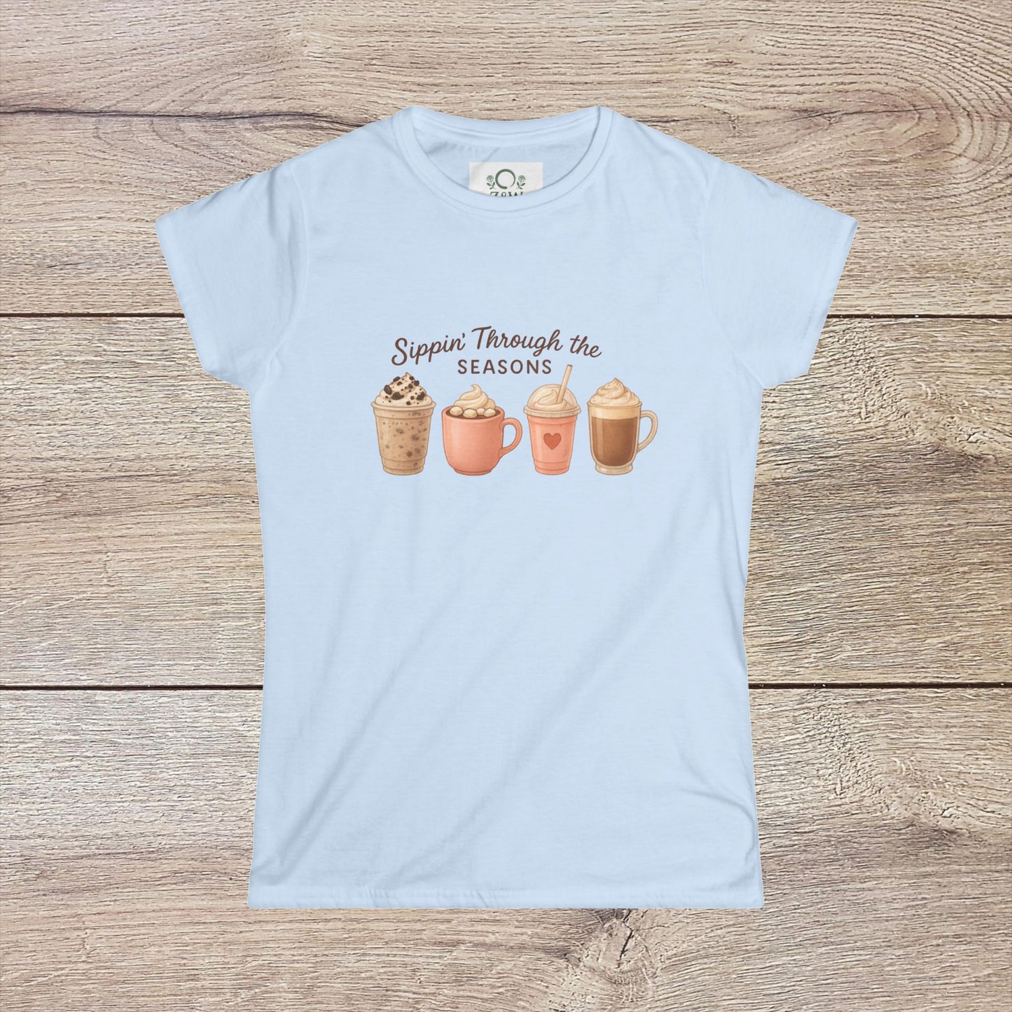 Sippin' Through The Seasons Slim Fit Tee in soft blue, featuring printed seasonal drink designs, made of 100% combed cotton with a comfortable fit.