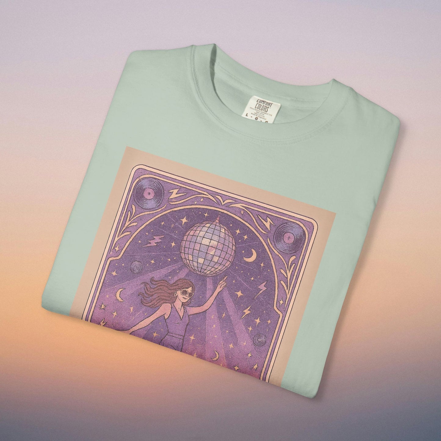 Groove Tarot Graphic Tee in pastel mint green, featuring a captivating design of a woman with a disco ball, ideal for fashion lovers seeking a trendy look.