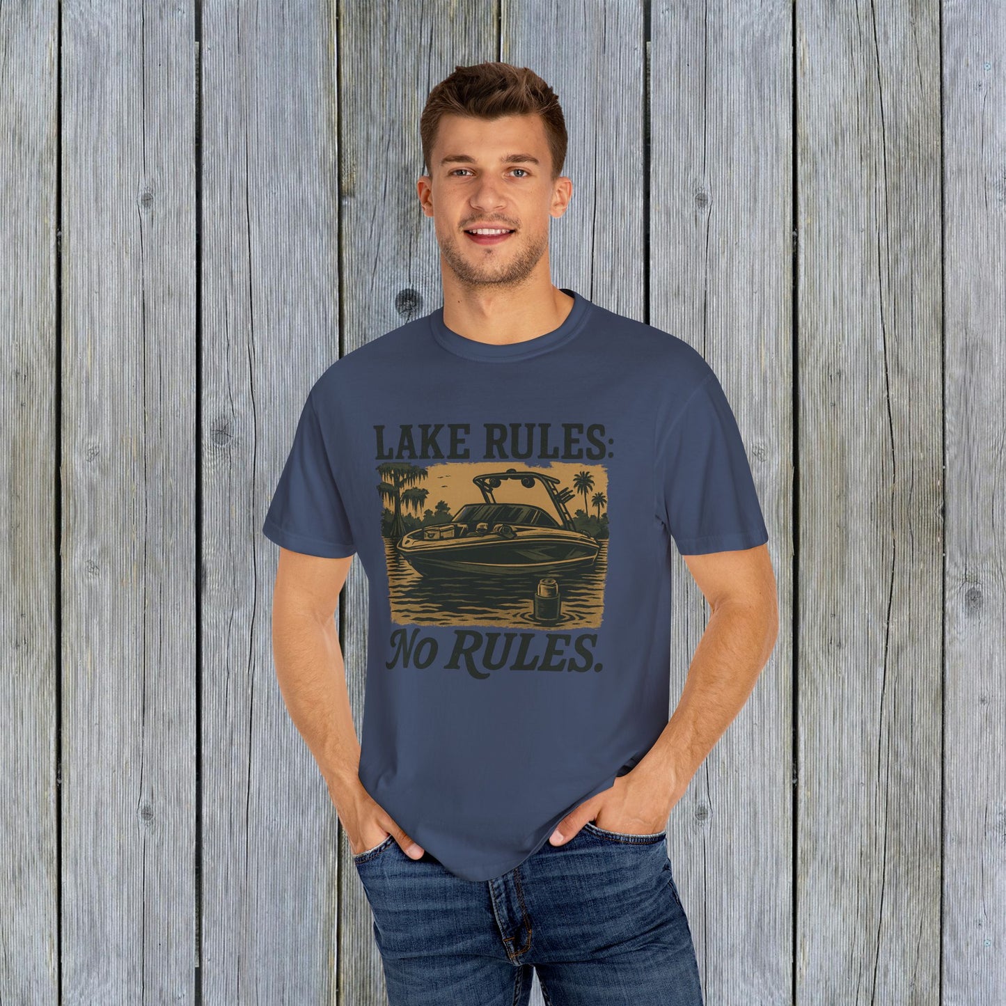 Unisex Garment-Dyed Lake Rules Tee - Soft Vintage Fabric, Sizes S to 4XL, perfect for outdoors, modeled by a male against a wooden background, promoting relaxed outdoor style.