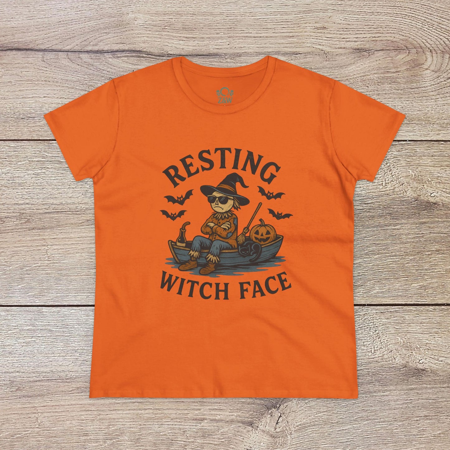 Resting Witch Face Halloween T-Shirt for Women, featuring a vibrant orange shirt with a cartoon witch graphic, perfect for Halloween fun and themed gift giving.