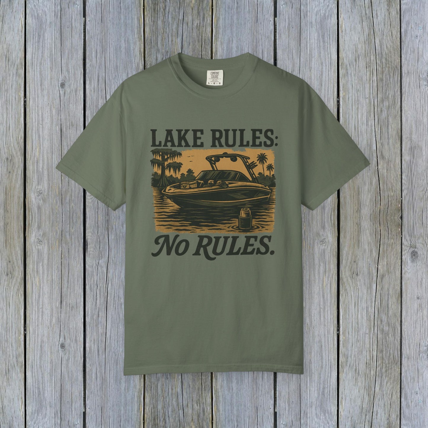Unisex Garment-Dyed Lake Rules Tee in sage green featuring a boat on a lake with 'Lake Rules: No Rules.' caption, made with soft vintage fabric, perfect for casual outings.