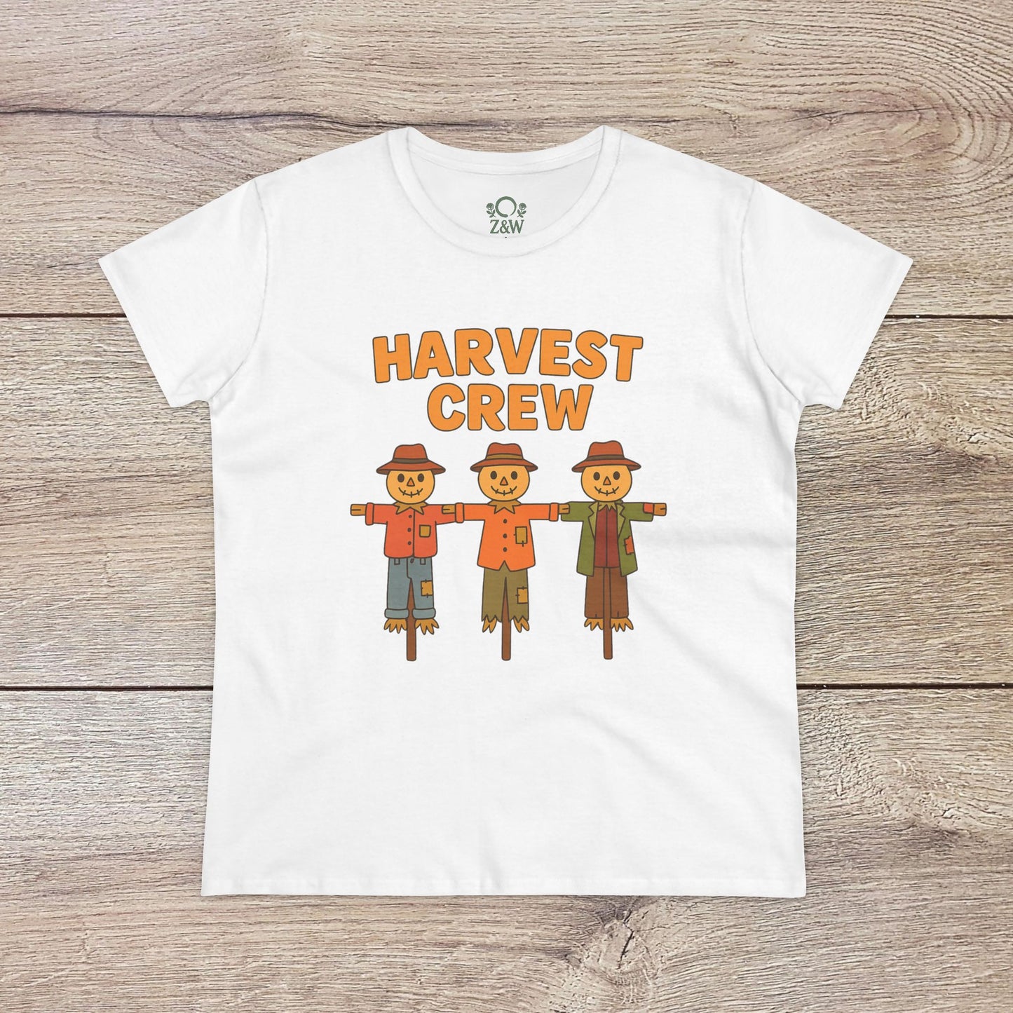 Harvest Crew Halloween T-Shirt featuring a playful design of three scarecrows standing together, perfect for festive celebrations. Made of soft 100% ring-spun cotton.