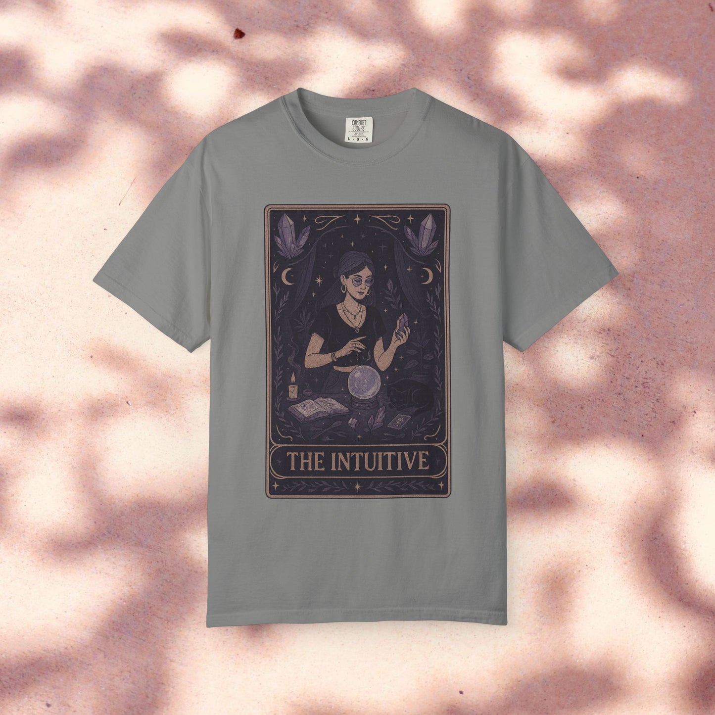 Intuitive Tarot Tee in soft grey, featuring an artistic design of a woman with tarot cards and a crystal ball, made from premium 100% cotton.