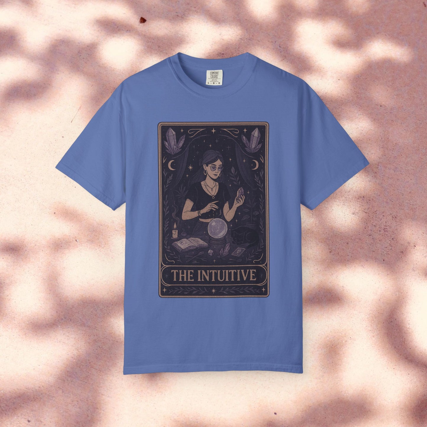 Intuitive Tarot Tee in vibrant blue, highlighting a captivating design of a woman with tarot cards and a crystal ball, crafted from soft 100% cotton.