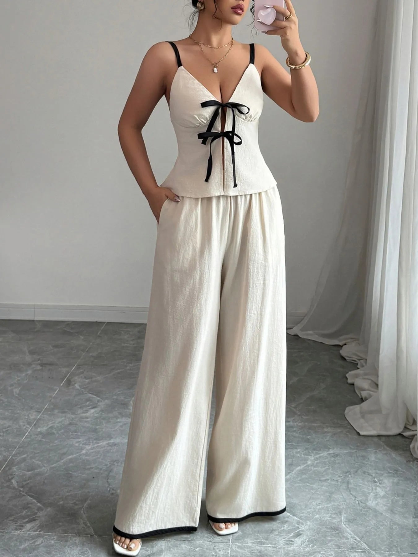 Model wearing the Trendy 2-Piece Tie Front Cami and Pocketed Pants Set, made from 100% cotton, highlighting the chic tie front design and functional pockets.