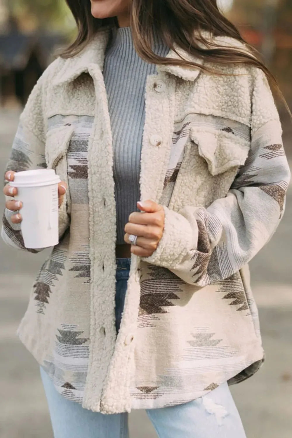 Trendsi Button Up Long Sleeve Jacket in beige and gray tones, showcasing a cozy texture, worn open over a gray sweater while holding a coffee cup.