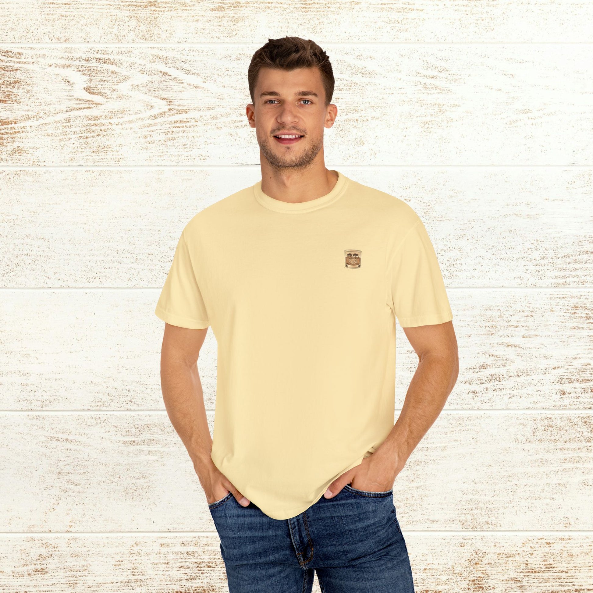 Model wearing the Rodeo On The Rocks Tee, featuring a drink logo on the chest, styled casually with jeans to create a relaxed look.
