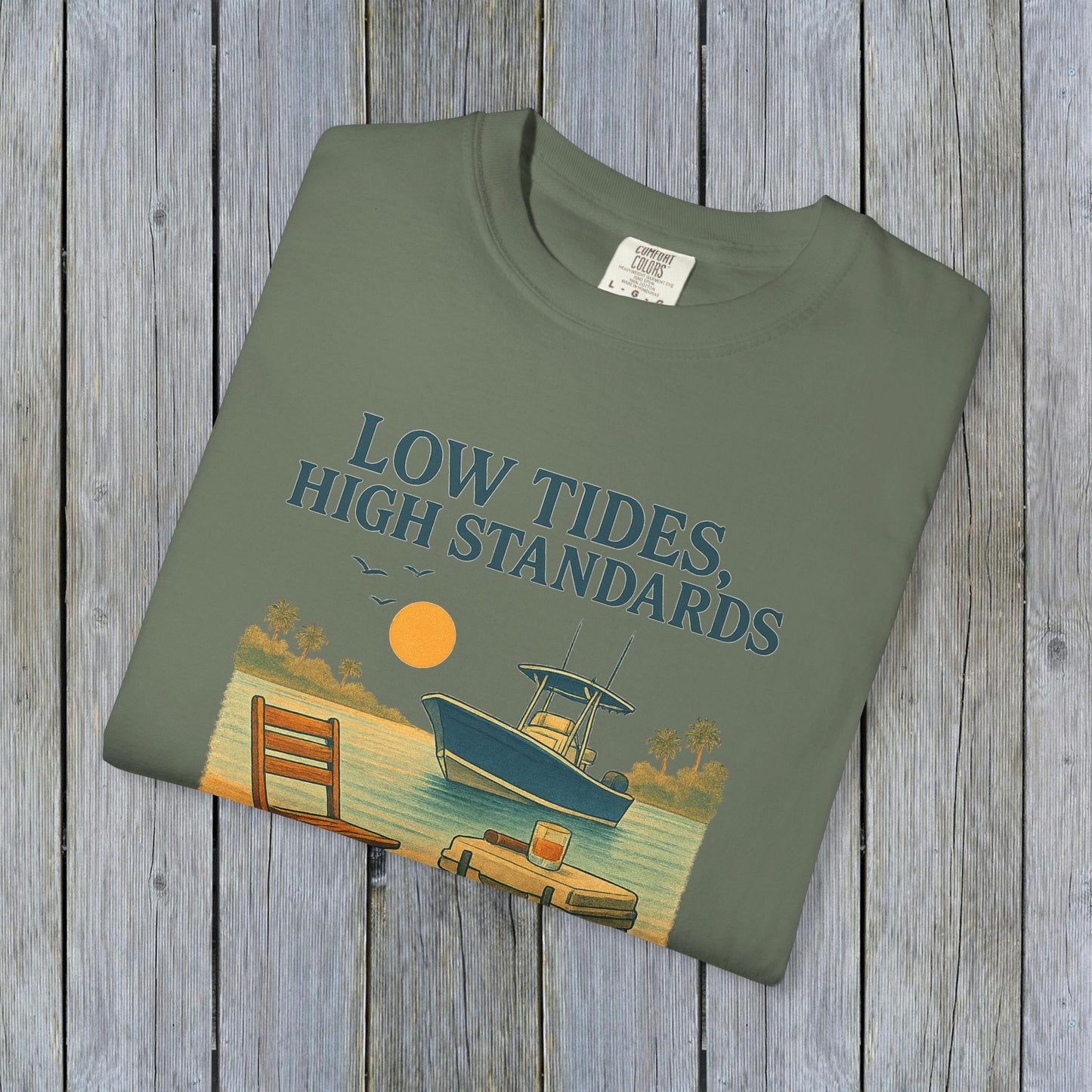 Garment-Dyed Low Tides High Standards T-Shirt in olive green, showcasing a graphic of a boat at sunset, perfect for casual outings and beach adventures.