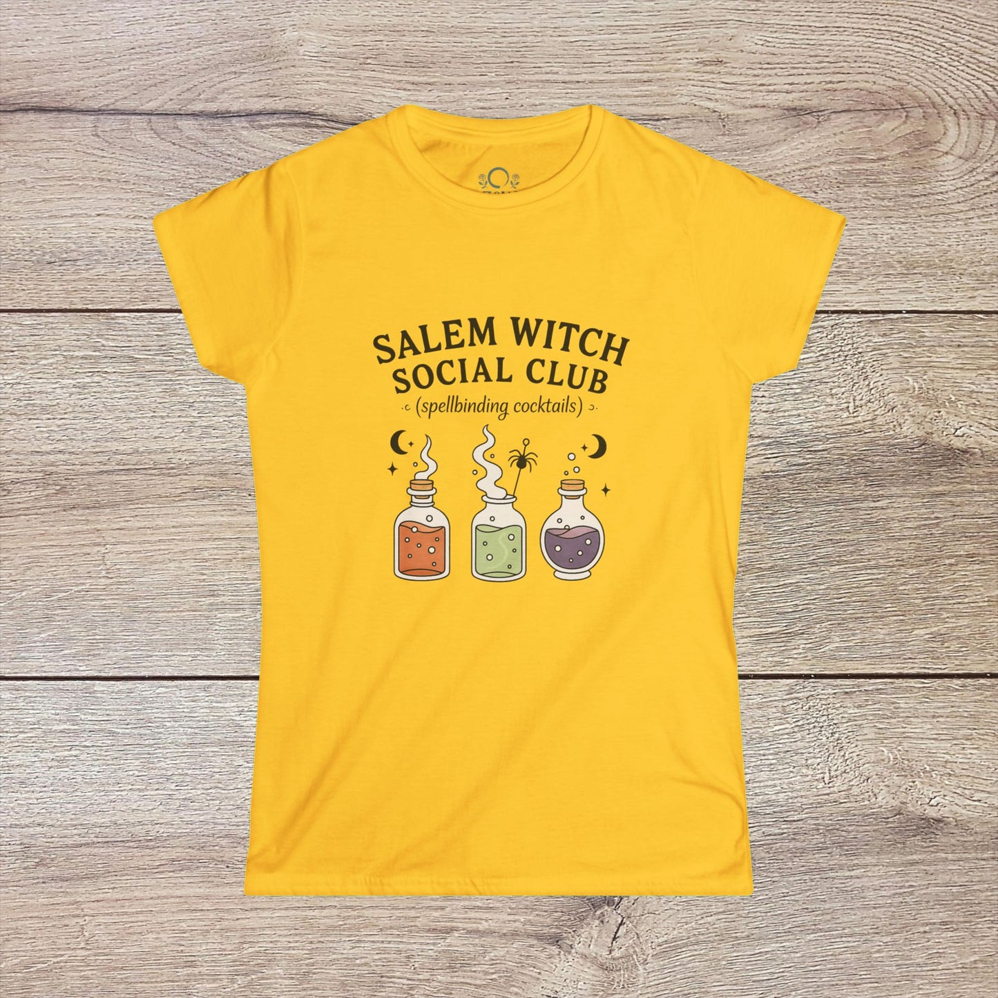 Salem Witch Social Club Graphic Tee displaying enchanting potion bottles and spellbinding cocktails on a bright yellow background, made from soft 100% ring-spun cotton for a whimsical touch.