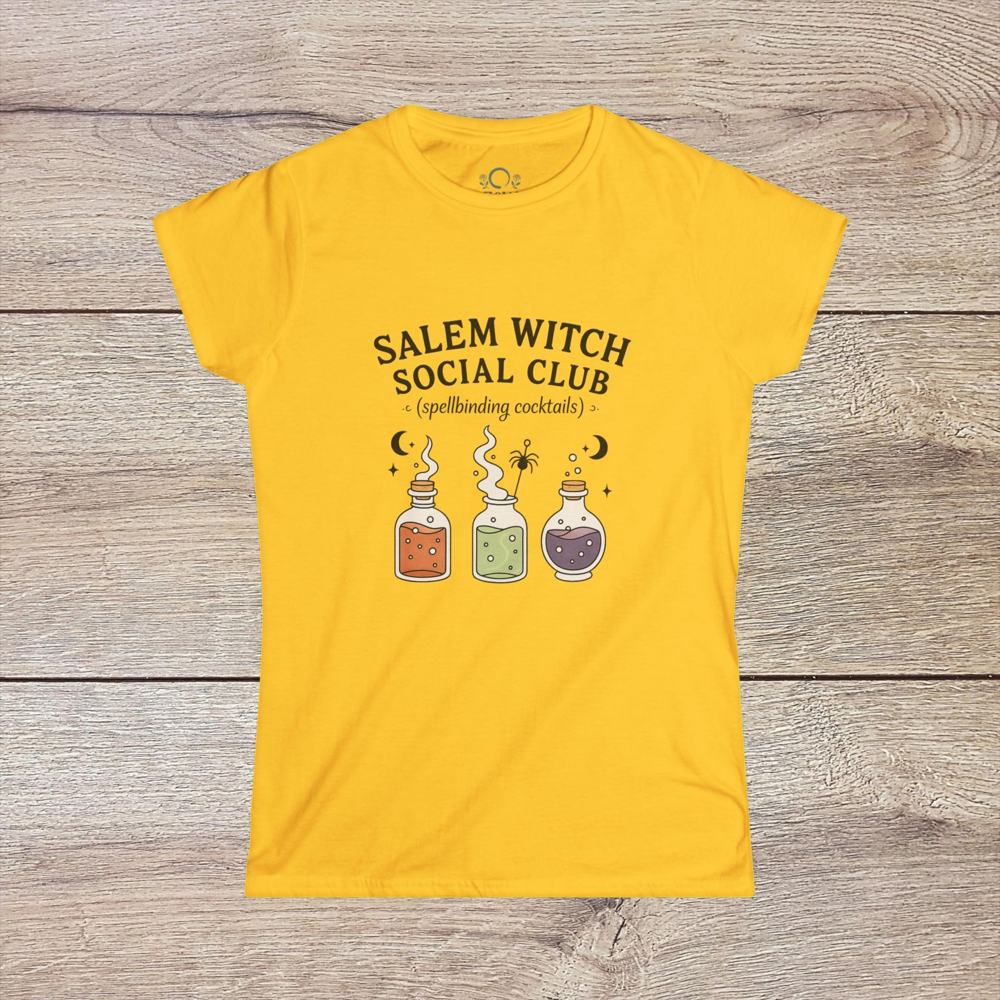 Salem Witch Social Club Graphic Tee displaying enchanting potion bottles and spellbinding cocktails on a bright yellow background, made from soft 100% ring-spun cotton for a whimsical touch.