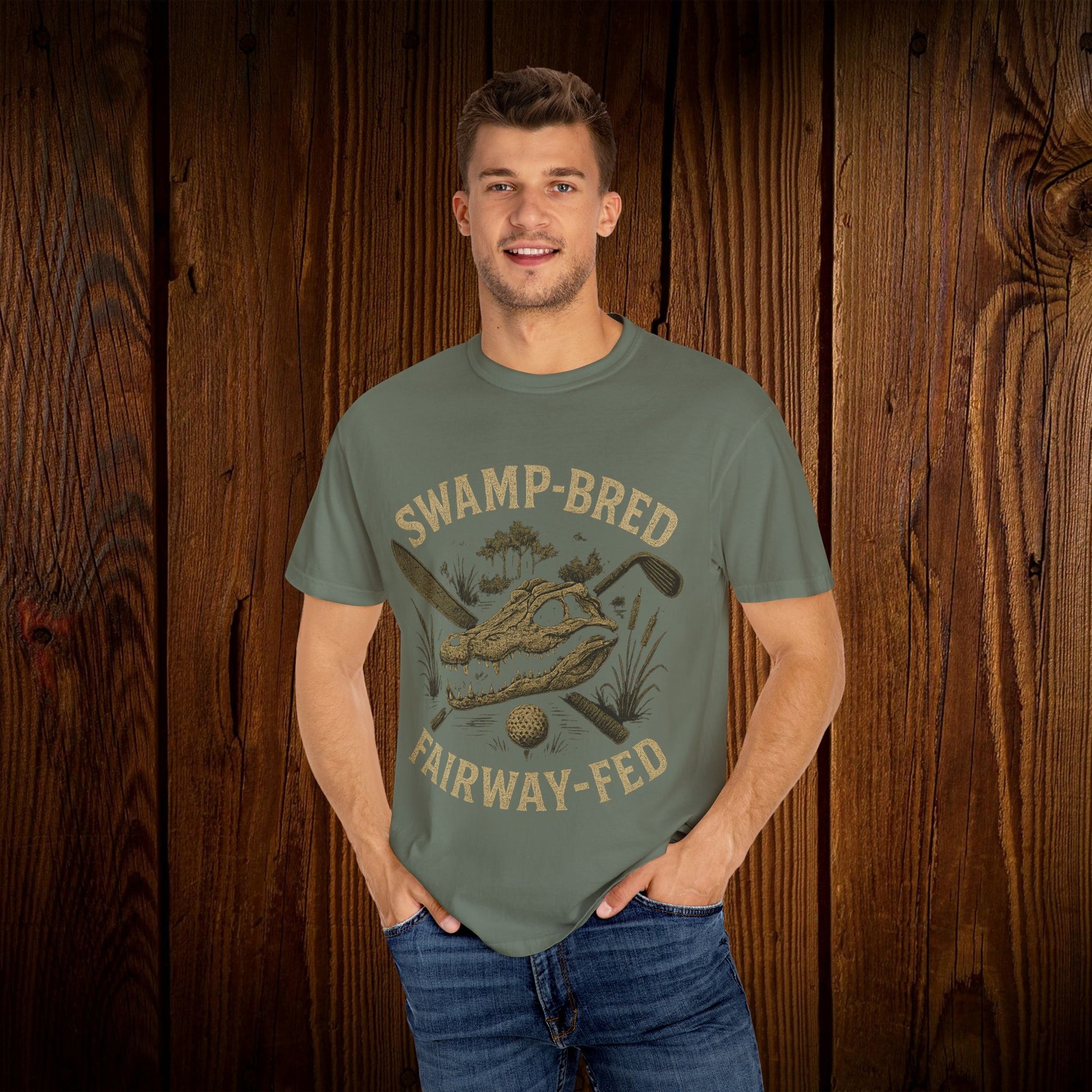 Model wearing the Unisex Swamp-Bred Fairway-Fed Tee in olive green, showcasing the unique design with a golf club and swamp scene, made for comfort and style.