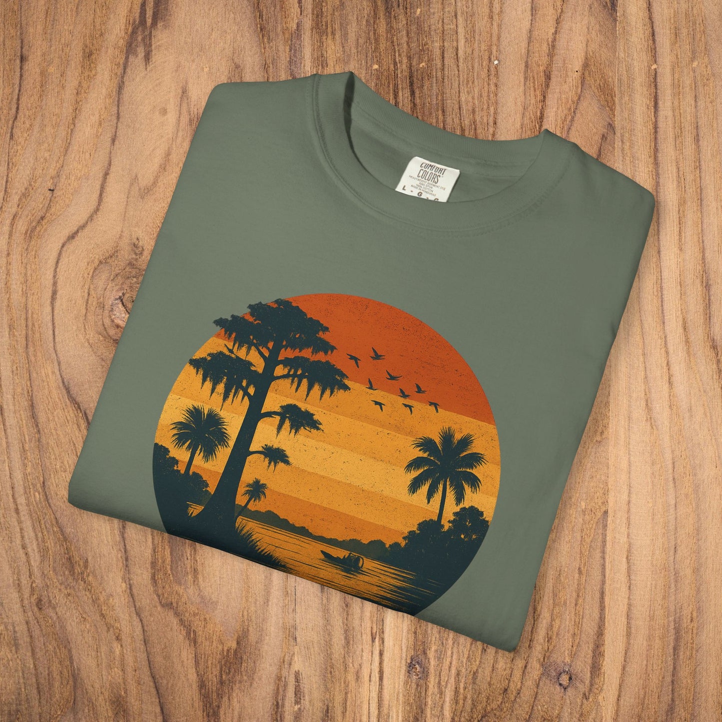 Unisex Garment-Dyed Sunset Tee - Soft 100% Cotton T-Shirt in olive green showcasing a vibrant sunset design with palm trees, ideal for relaxed style.