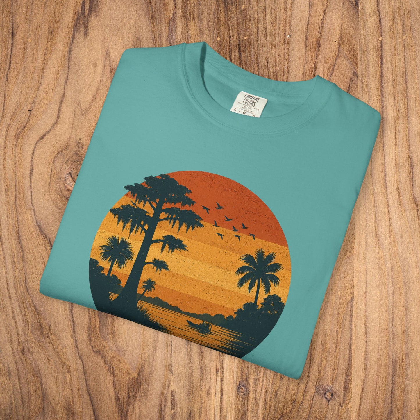 Unisex Garment-Dyed Sunset Tee - Soft 100% Cotton T-Shirt in teal, displaying a colorful sunset scene with palm trees, great for everyday wear.