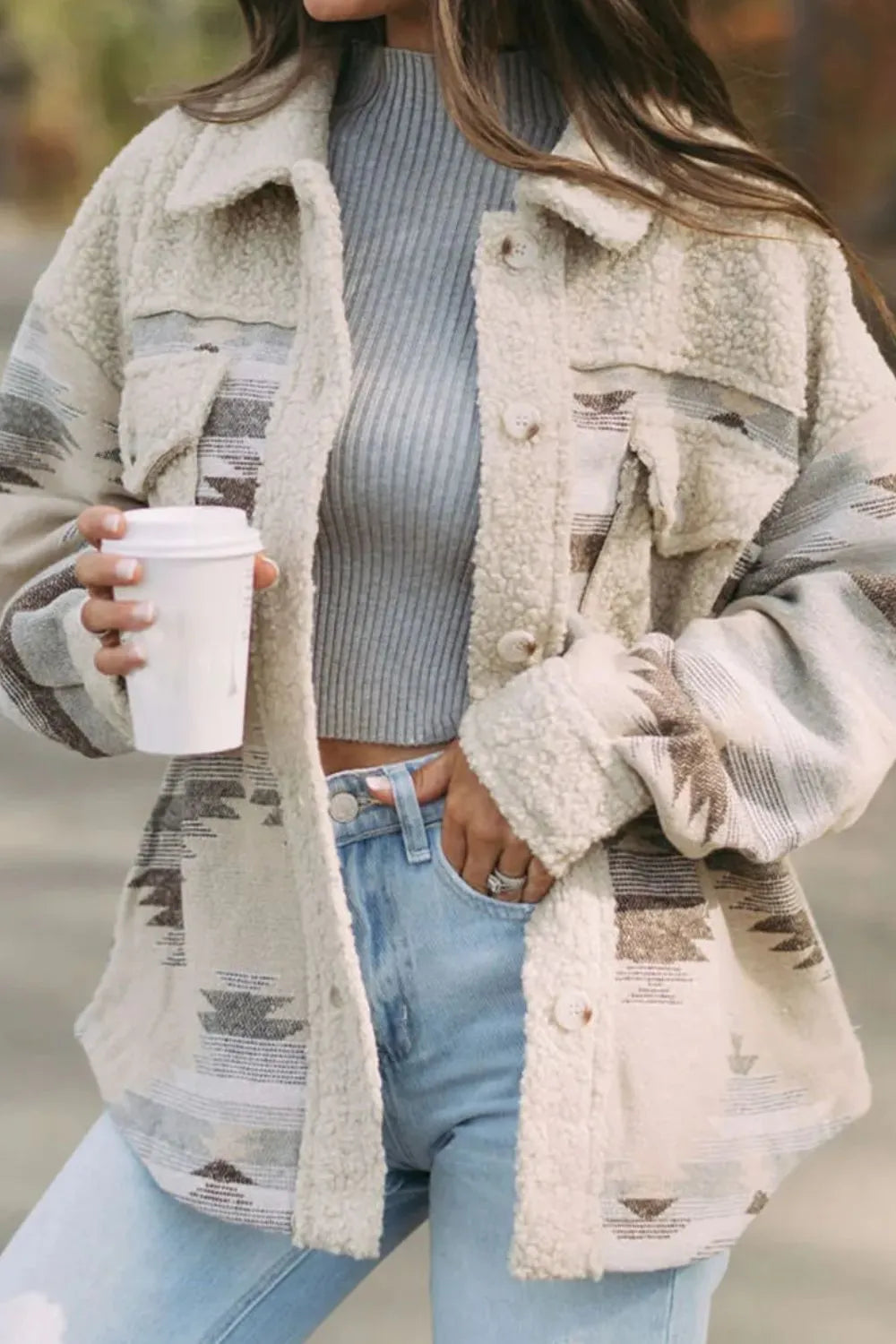 Trendsi Button Up Long Sleeve Jacket in beige, styled with a gray sweater and light blue jeans, highlighting its stylish and warm appeal.