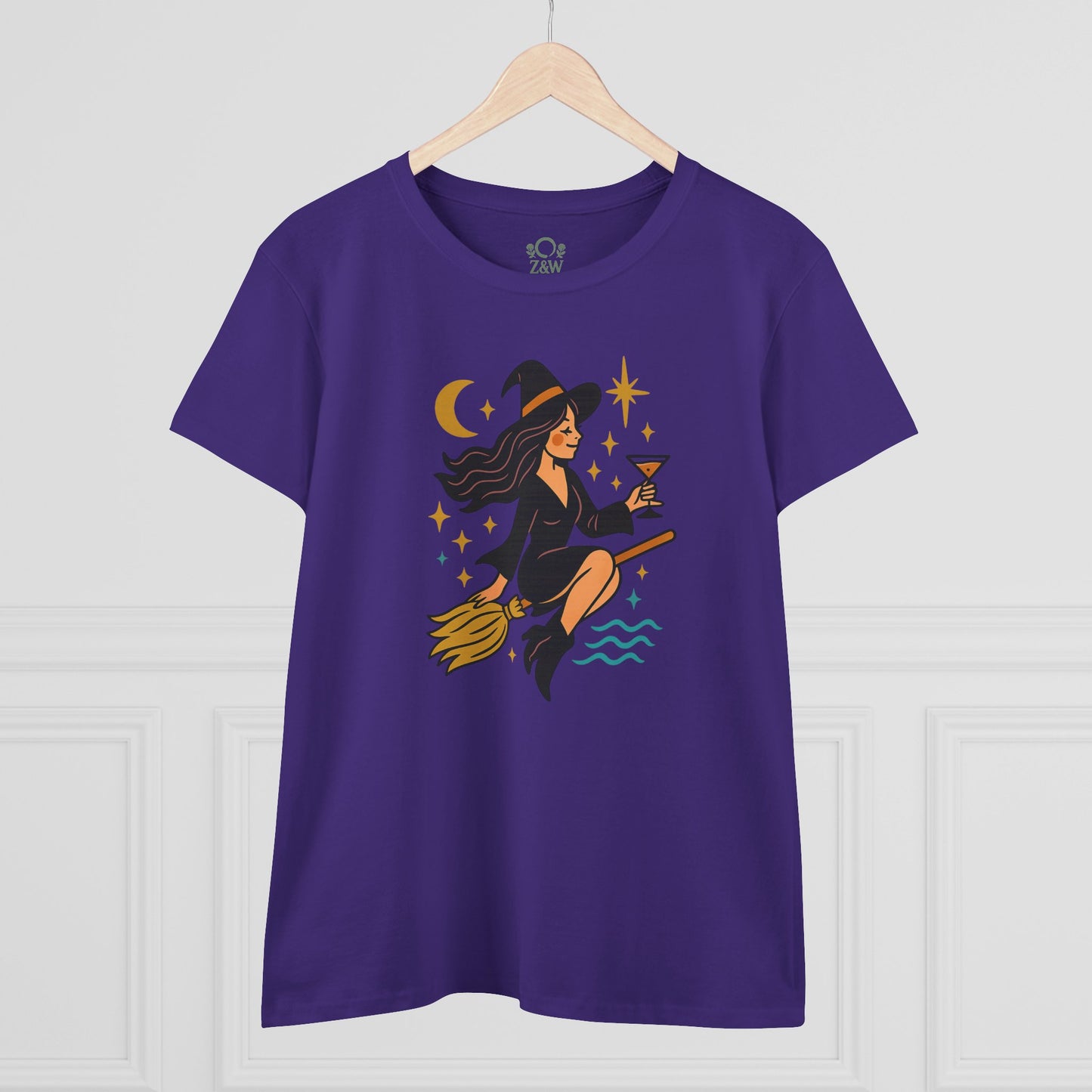 Front view of the Witchy Night Out Tee in purple showcasing a unique design with a witch on a broomstick, perfect for stylish, durable, and ethically made wear.